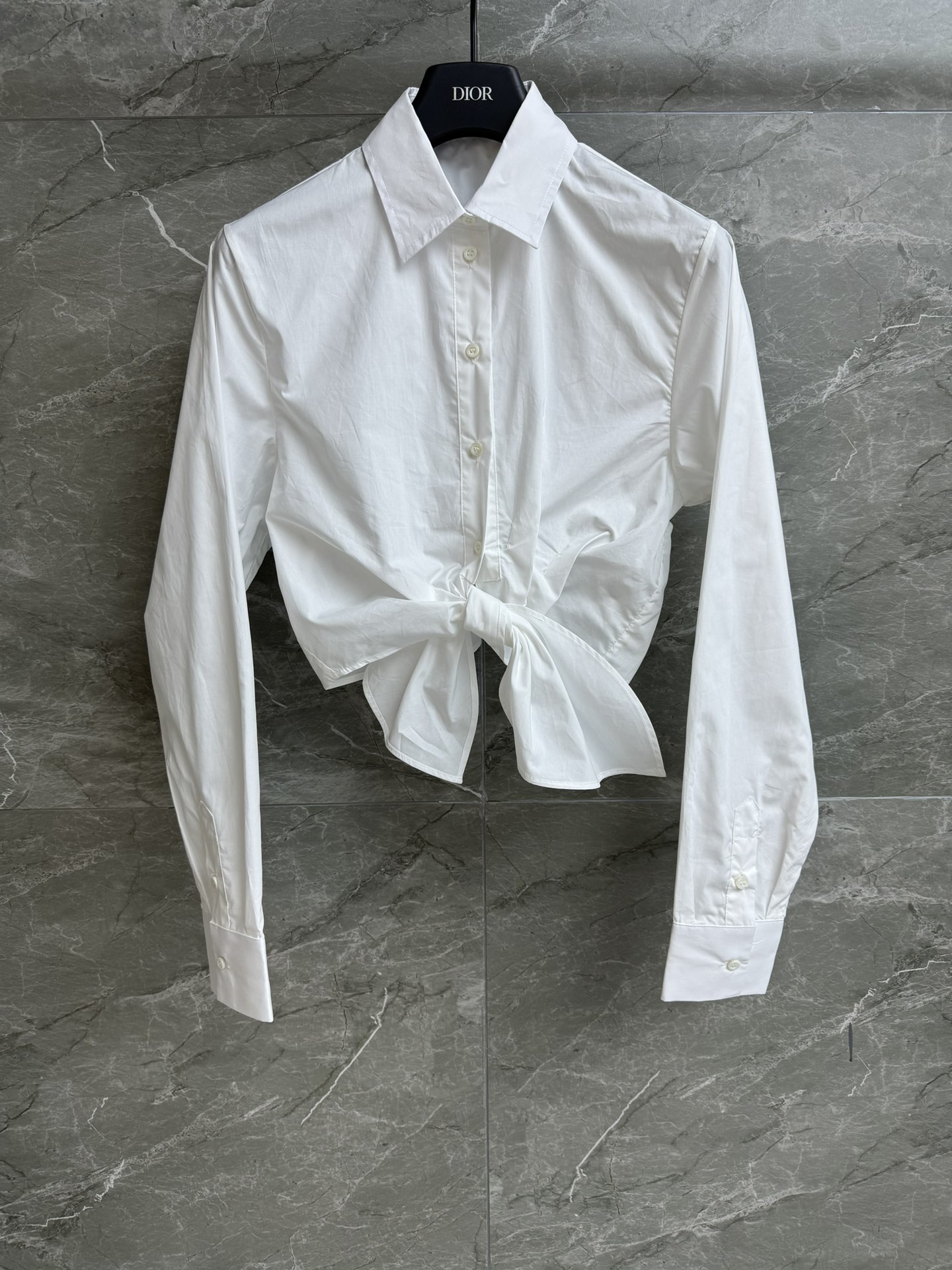 NO:333750,New models for early autumn are available. D-home lace-up short shirt. 2025 early autumn series. Lapel neckline. Hem lace-up design. Fashionable personality. Mother of pearl logo button decoration. Customized cotton poplin fabric. Comfortable and skin-friendly. Short style. Slim and versatile. Full trademark. Size SML,,dior,alexander wang.19860909早秋新款上新啦 D家系带短款衬衣 2025早秋系列 翻领领口 下摆系带式设计 时髦个性 珍珠贝母logo纽扣装饰 定制棉府绸面料 舒适亲肤 短款版型 上身显瘦又百搭 商标齐全 尺码SML,,dior,alexander wang,Women's clothing