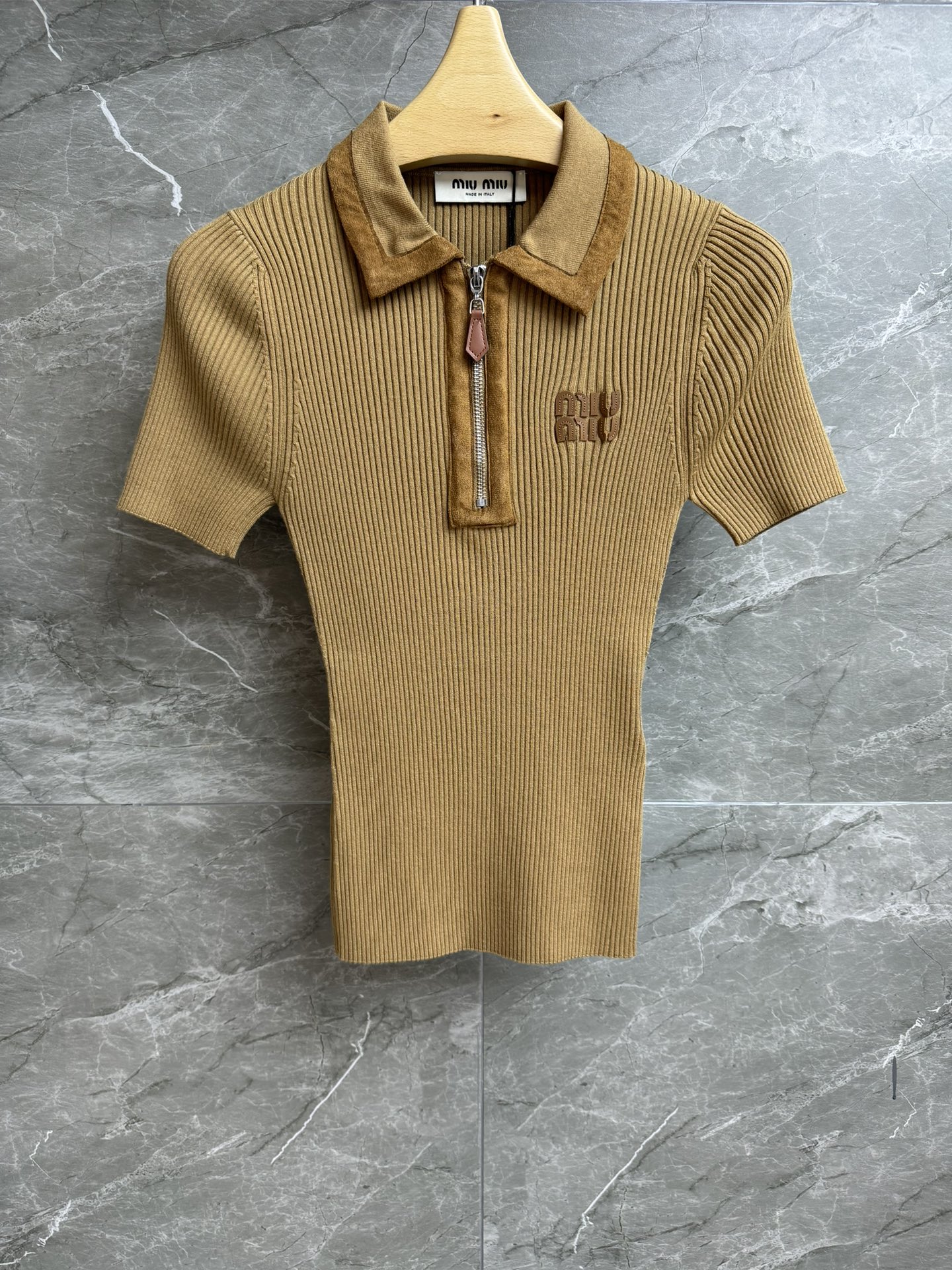 NO:479826,New models for early autumn are available. Miu suede spliced ​​short sleeves. 2025 early autumn series. Lapel zipper design. Suede spliced ​​trim. Alphabet patch embroidery embroidery. Retro and fashionable. Custom knitted fabric. Stretch slim fit. The upper body looks slim and versatile. Full trademark. Size smL,,miumiu, T-shirt,chamois leather,alexander wang.19860909早秋新款上新啦 Miu麂皮拼接短袖 2025早秋系列 翻领拉链设计 麂皮拼接饰边 字母贴布刺绣点缀 复古时髦高级 定制针织面料 弹力修身版型 上身显瘦又百搭 商标齐全 尺码smL,,miumiu,T-shirt,chamois leather,alexander wang,Women's clothing