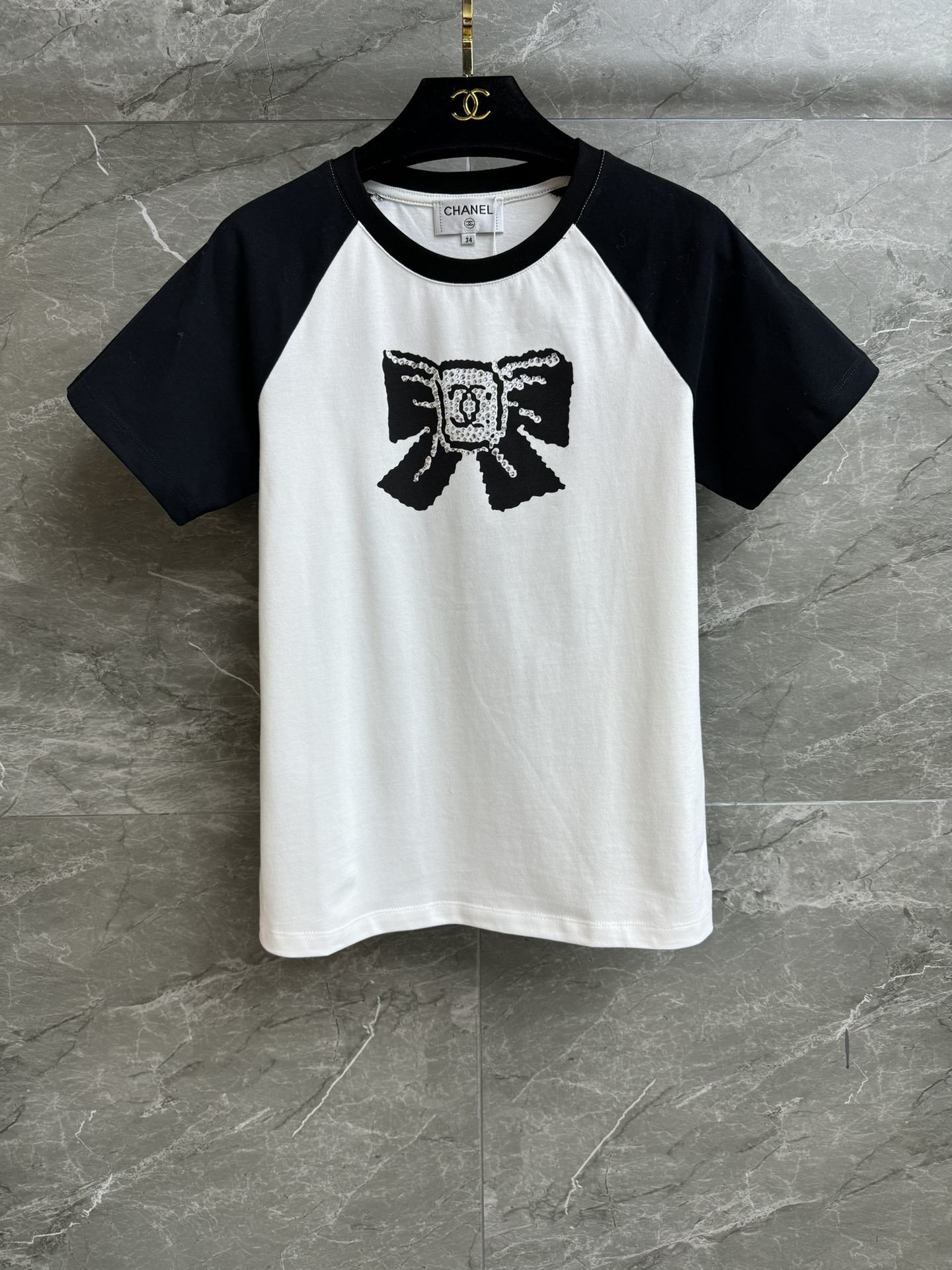 NO:569485,The new style of early autumn is available. Xiangjia bow printed T-shirt 2025 early autumn series. Round neck raglan sleeve design. Hot diamond bow printed pattern. Black and white color matching, fashionable and age-reducing. Imported pure cotton fabric. Comfortable and skin-friendly. Normal fit. The upper body is slim and versatile. Complete trademarks. Sizes SML, chanel, tees, t-shirt, alexander wang19860909早秋新款上新啦 香家蝴蝶结印花T恤 2025早秋系列 圆领插肩袖设计 烫钻蝴蝶结印花图案 黑白拼色时髦减龄 进口纯棉面料 舒适亲肤 正常版型 上身显瘦又百搭 商标齐全 尺码SML,,chanel,tees，t-shirt,alexander wang,Women's clothing