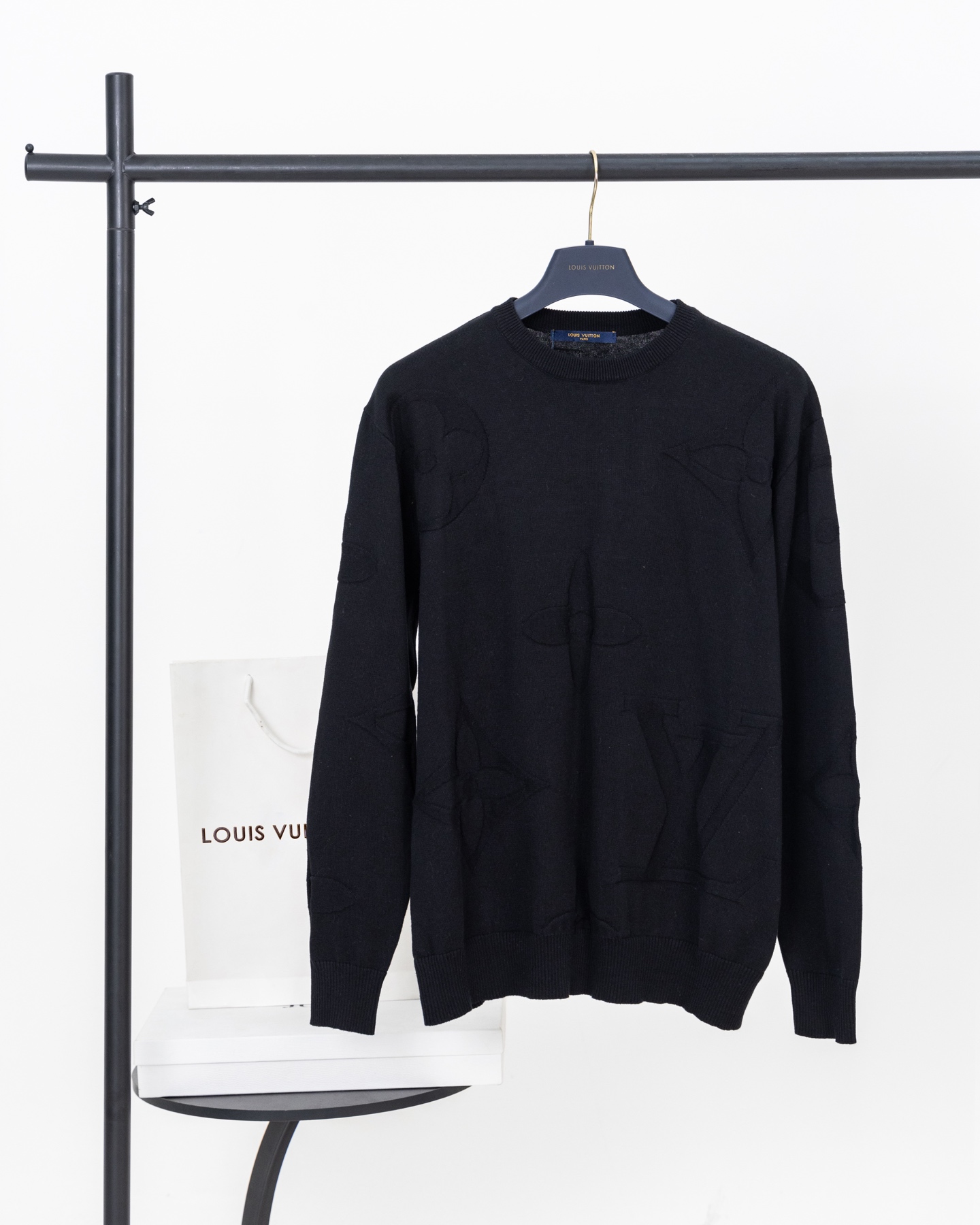 💰145【顶级版本.官网品质】
LOUIS VUITTON*路易威登
LV  MONOGRAM图案圆领毛衣

本款棉质圆领衫为全幅图案渲染深邃色调，于柔软提花针织融入大号花卉和 1V 标识，可为各式造型注入考究气息。

核心技术体现在全幅提花工艺，采用14针细针进口织机，以高达32S的高粘棉质纱线为载体，通过数字化编程的经纬纱线交错。将放大比例的花卉与1V标识直接织入面料结构，赋予其独特的压纹凹凸质感，在视觉与触觉层面同时建立起立体层次。

高支高密纱线配合极细针距，创造出致密柔软且具备优异抗起球性的织物基底。高粘处理技术极大增强了棉纤维的韧性与回弹，使成衣在多次穿着后仍能保持挺括形态，克服了纯棉针织易变形的天然缺陷。

款号：9601#
颜色：黑色
尺码：S M L XL