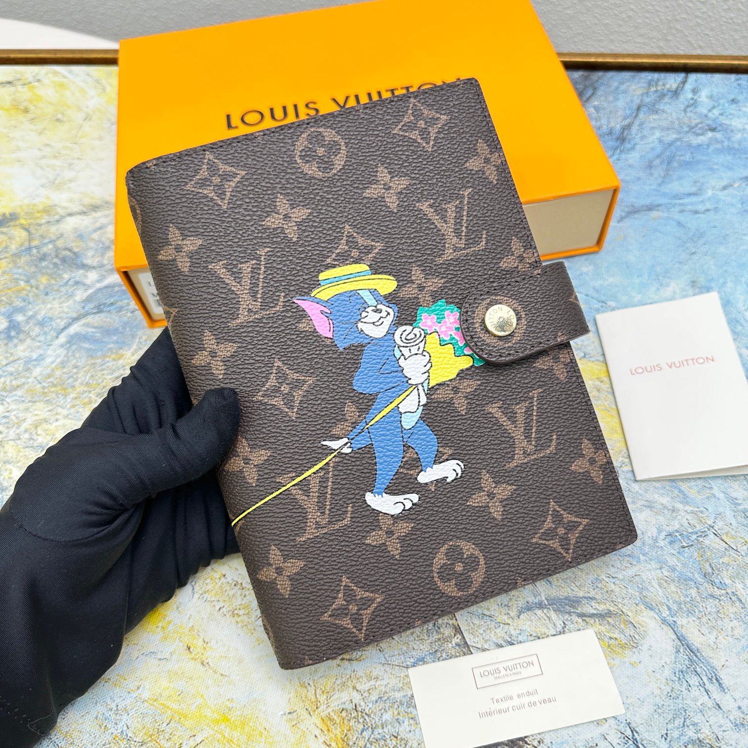 Close up of the binding on a small leather notebook.