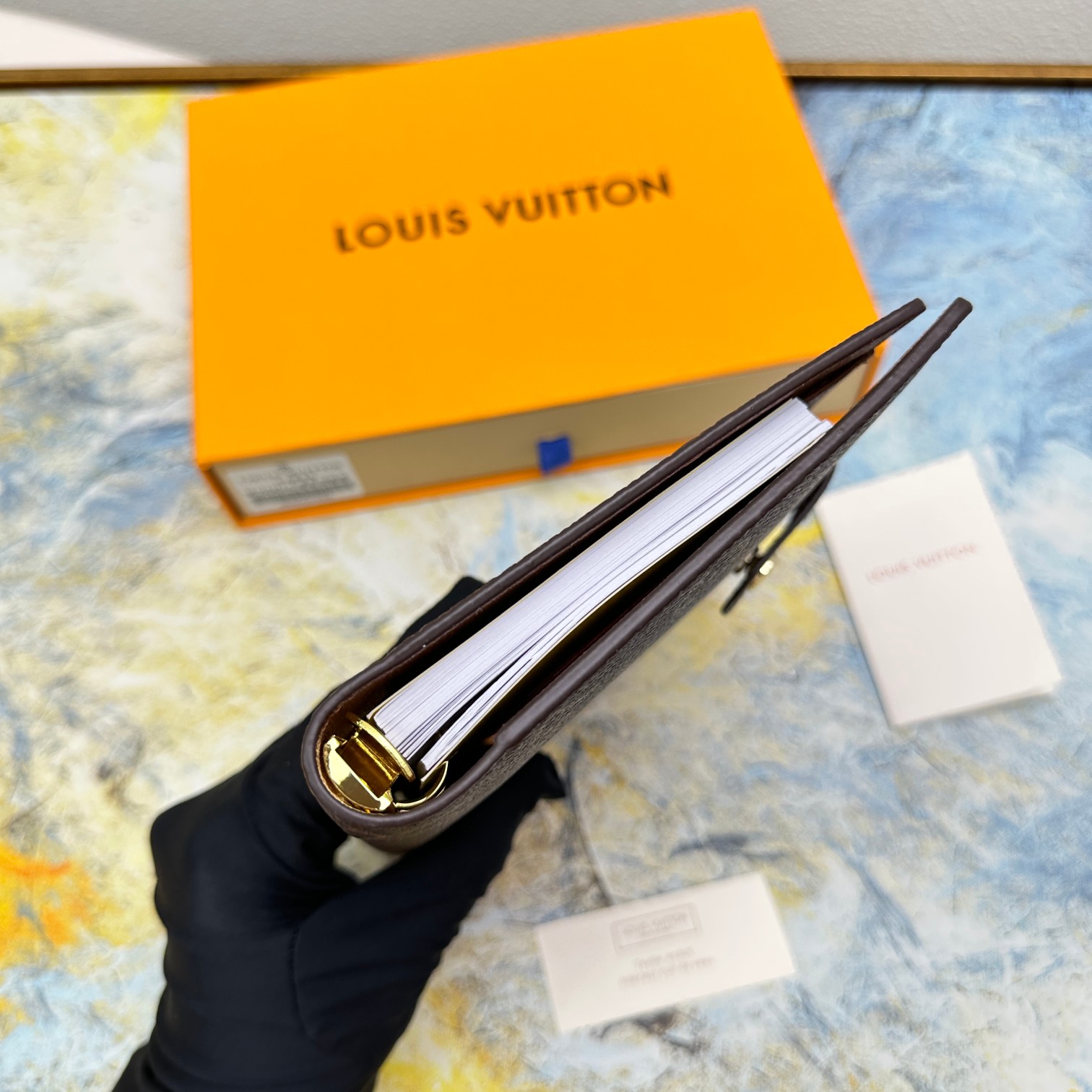 Close-up of stitching detail of a leather notebook