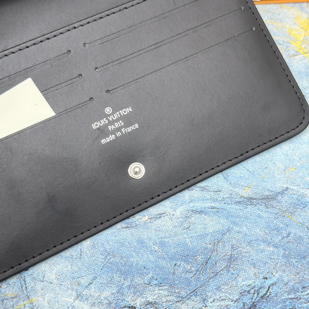 Long leather wallet being held in hand