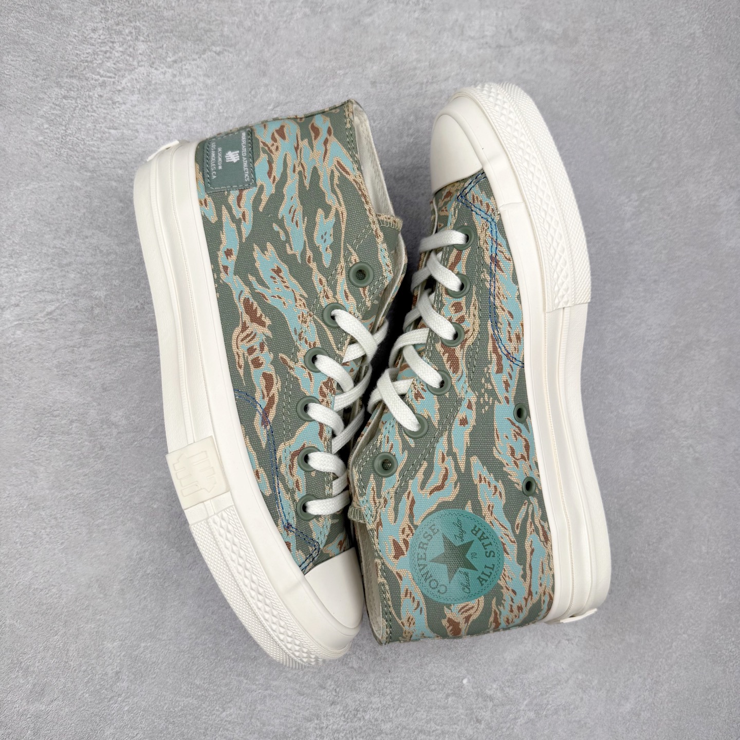 图片[3]-UNDEFEATED x Converse 1970S Mid 匡威联名 休闲复古中帮帆布鞋 鞋款采用Chuck 70 Mid 鞋型进行设计，在高帮与低帮中找到舒适与美观的平衡点，并沿袭前作中的UNDEFEATED标志性美学，再搭配鞋舌与后跟标处的5-Stike Logo编铭牌，联名标志处处可见，营造联名氛围之余更将质感拉满。 货号：172397C 绿迷彩 货号：A00673C 黑色 货号：A00670C 白色 尺码：35 36 36.5 37 37.5 38 39 39.5 40 41 41.5 42 42.5 43 44-选品中心