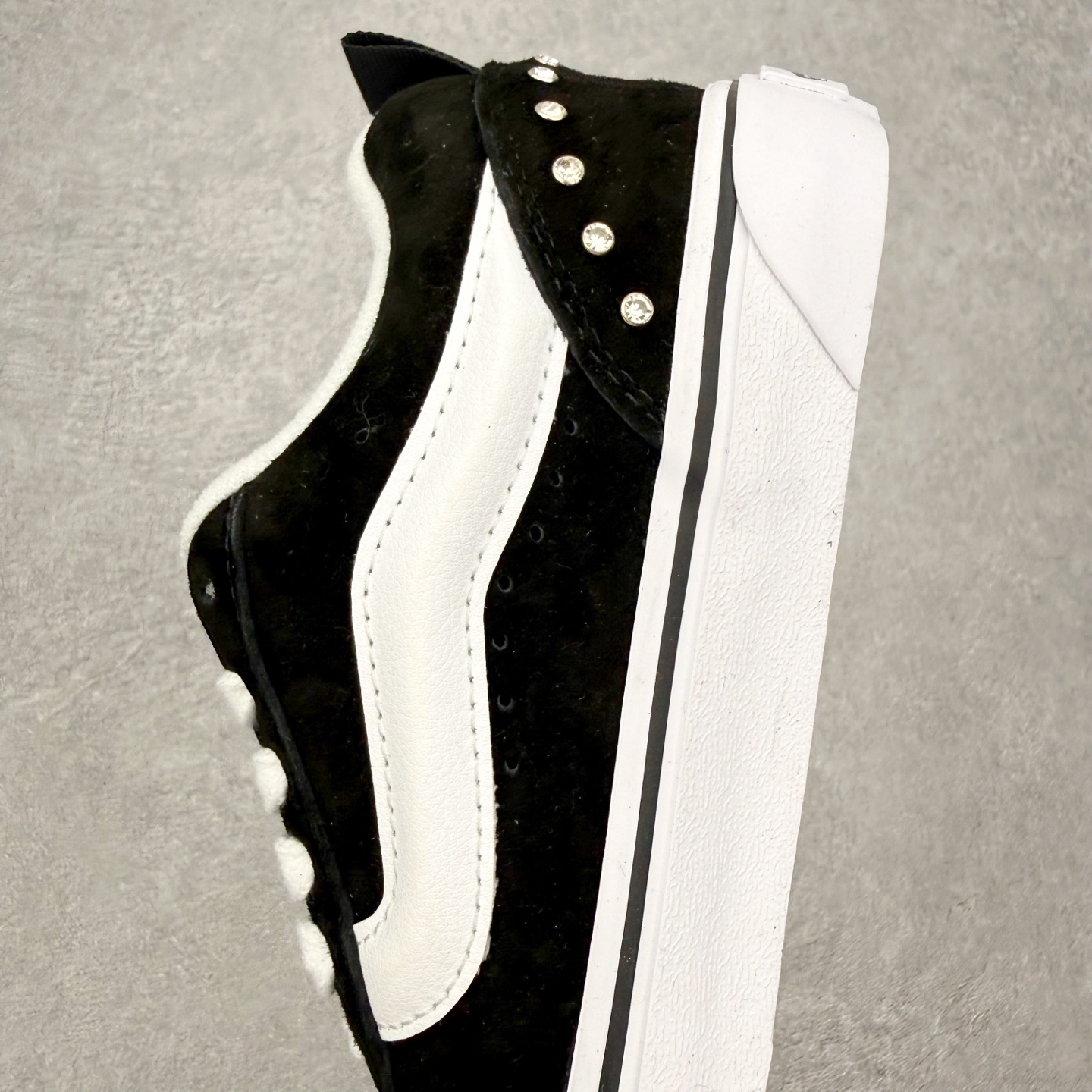 Vans Knu Skool 碎钻铆钉面包鞋此次以碎钻元素为设计亮点，黑白经典配色为基底，全麂皮鞋面搭配