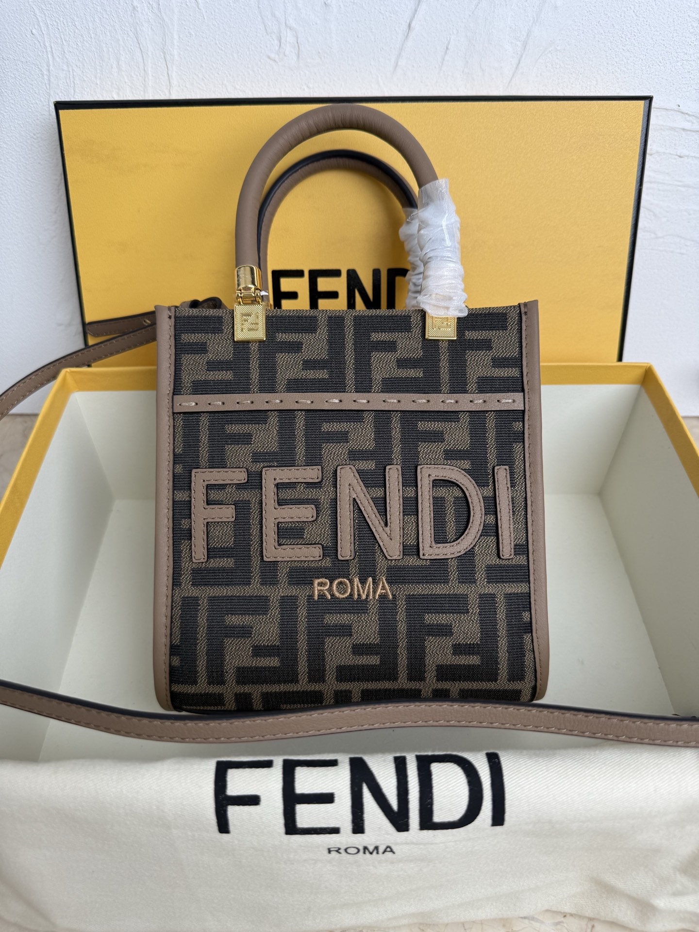 NO:206253,Sunshine small tote bag, fabric material, decorated with FF pattern jacquard, sand and stone color FEND1 ROMA leather lettering. Sand and stone color plexiglass hard handle. Features spacious inner compartment with inner lining, sand and stone color leather edges and gold metal parts. Equipped with two handles and removable shoulder straps, for hand or shoulder shoulder. Model number 8042 Size 16.5*5*17cm, Fendi, fendi, fendi19860909Sunshine小号手提袋,布料材质,饰有FF图案提花,沙石色FEND1 ROMA皮质字样.沙石色有机玻璃硬质手柄.设有宽敞的带内衬内部隔层,沙石色皮革边缘和金色金属件.配备两个提手和可拆卸肩带,可手提或肩挎.款号 8042 尺寸16.5*5*17cm,芬迪,fendi,fendi,Bag