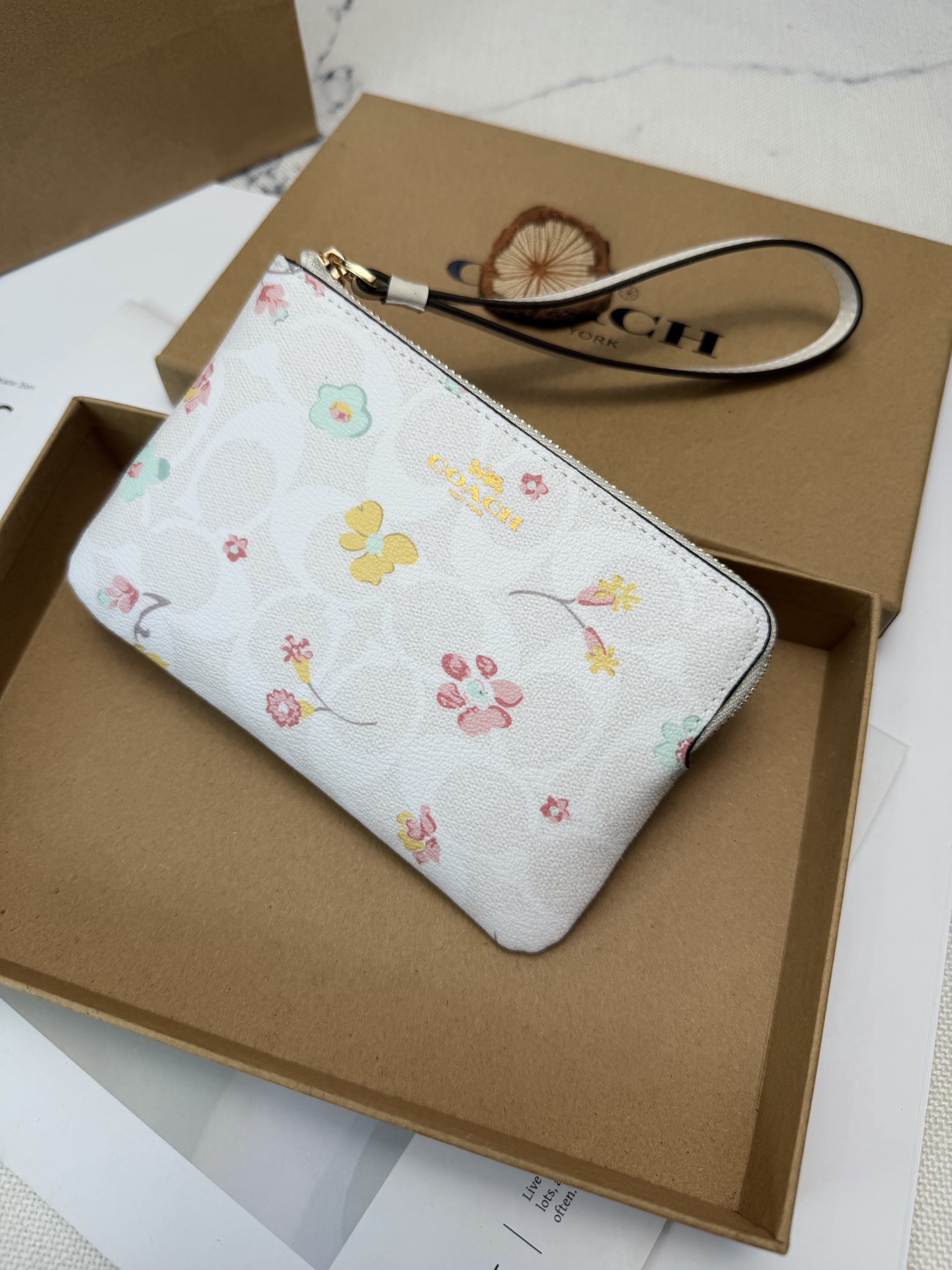 Coach 采用白色牛皮 搭配多彩花卉图案