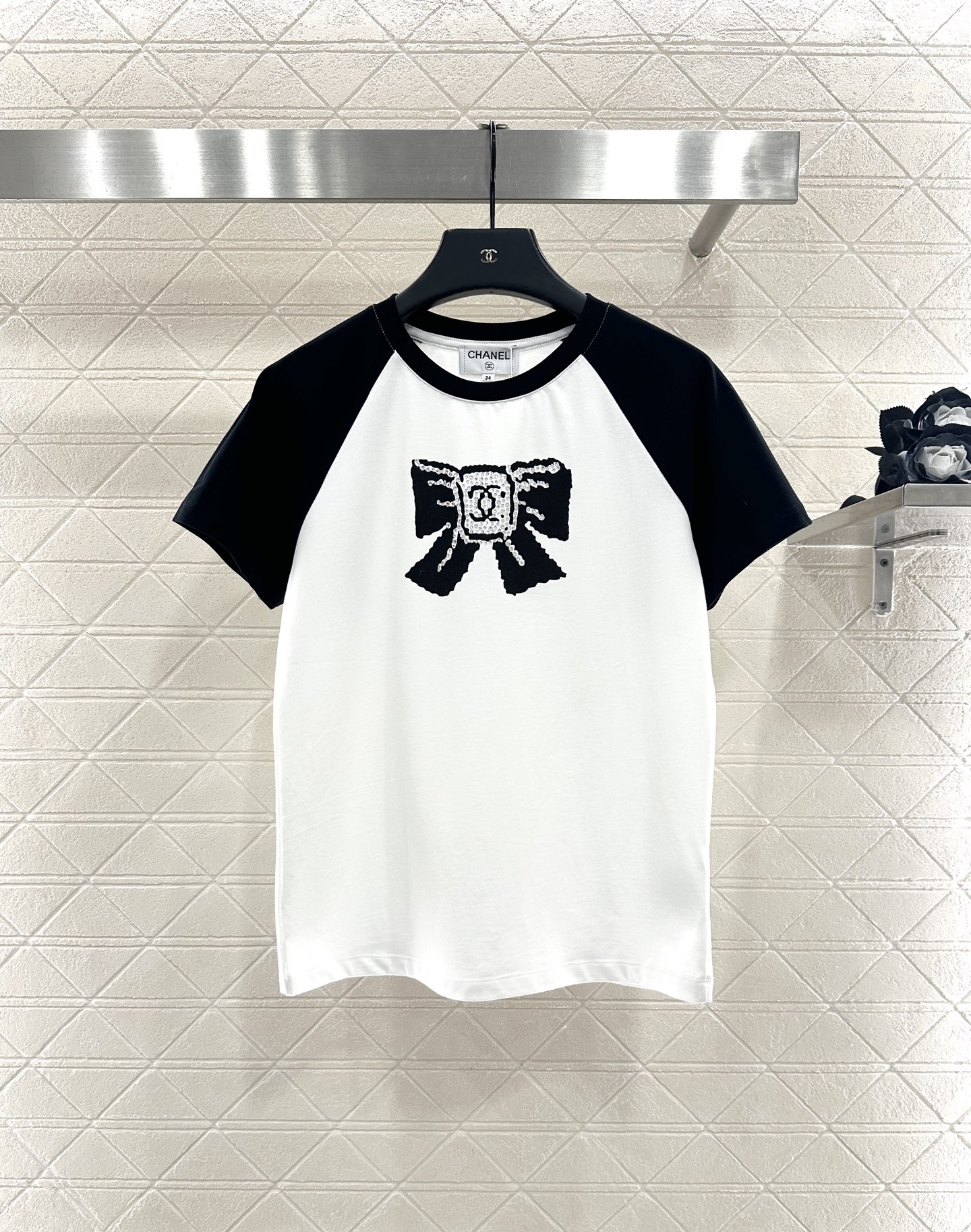 Chanel Women's White T-Shirt with Black Sleeves and Bow Accent