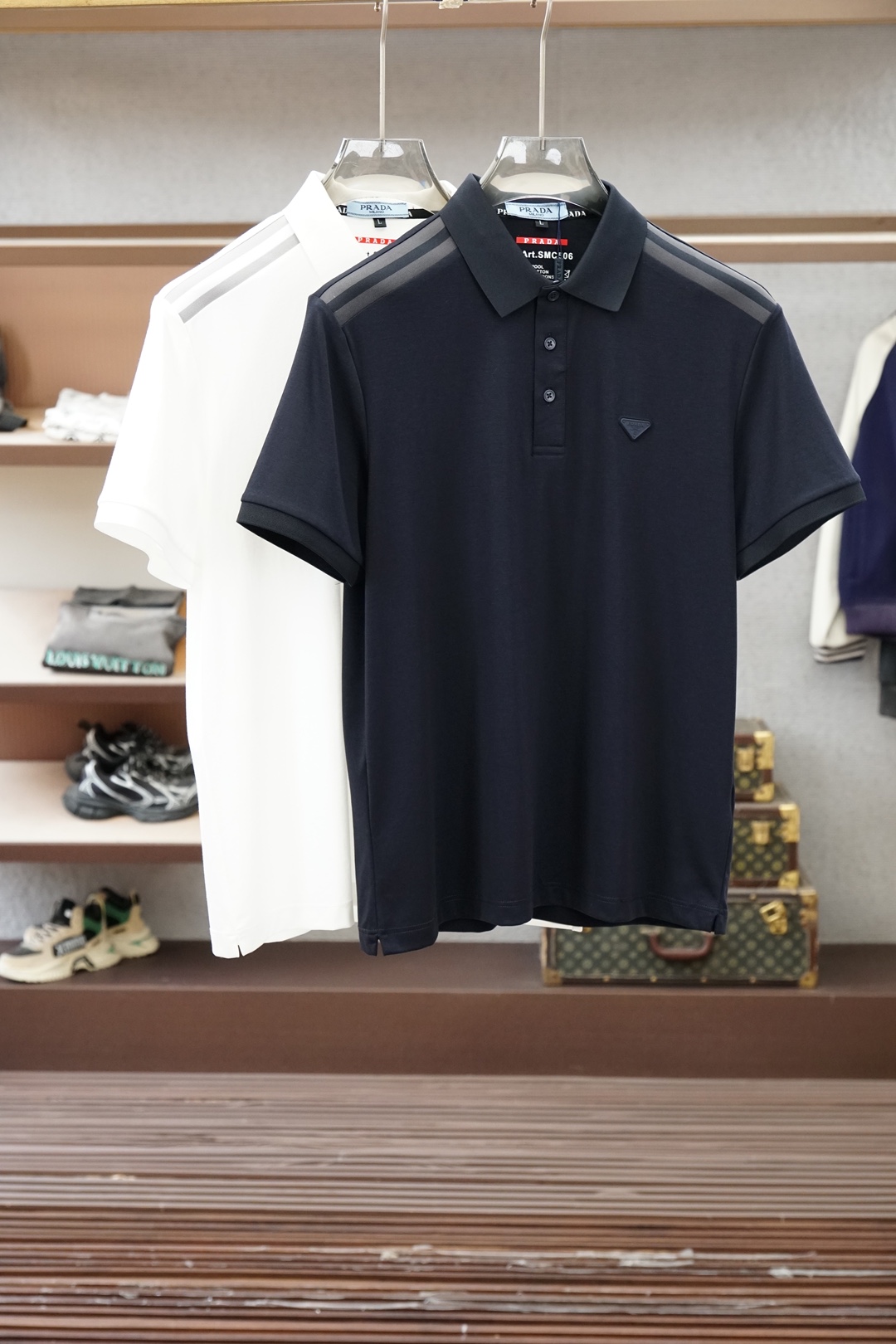 NO:836645,Prada, Prada- 2026ss new product launched, classic refreshed high-end pique Polo shirt  The fabric is made of black technology, giving you a comfortable and luxurious feeling. It is made of double-sided pique mesh fabric. The three-dimensional pique texture is intertwined with warp and weft. It has a breathable mesh structure. It keeps the skin dry at all times when wearing it in summer, saying goodbye to stuffiness and stickiness. The double-sided weaving process makes the fabric more stiff and wear-resistant, and can be worn for a long time.  It is not easily deformed and can be worn with any outfit. It is neat and stylish. It is anti-wrinkle and easy to care for, making it the best choice for business trips. The classic Polo collar is matched with contrasting striped piping, and the neat lines outline the neck, giving it a sense of business formality. The exquisite embroidery logo on the left chest is a low-key statement.  The brand style is unobtrusive yet self-recognizable; whether worn alone for casual everyday use or worn under a suit for a business elite look, it can easily hold up in various scenarios. From fabric selection to cutting and sewing, every process follows the production standards of big brands, and three-dimensional tailoring fits perfectly.  The body shape is not tight, taking into account comfort and shape aesthetics. The fusion of double-sided pique texture and classic design makes this Polo shirt not only a piece of clothing, but also a business card of your taste. Sizes M-3XL, prada, prada, business  suit,19860909普拉达,Prada- 2026ss新品上线 经典焕新高端珠地Polo衫 面料黑科技,穿出来的舒适奢感,采用双面珠地网眼面料打造,经纬交织的立体珠地肌理,自带透气网孔结构,夏日穿着时刻保持肌肤干爽,告别闷热黏腻；双面织造工艺让面料更挺括耐磨,久穿不易变形,随手一搭都是利落型格,抗皱易打理的特性,更是商旅出行的不二之选.经典Polo领搭配撞色条纹滚边,利落线条勾勒颈部轮廓,商务正式感拉满；左胸精致刺绣标识,低调彰显品牌格调,不张扬却自带辨识度；无论是单穿打造休闲日常,还是内搭西装诠释商务精英范,都能轻松hold住各种场景.从面料甄选到剪裁缝制,每一道工序都遵循大牌制作标准,立体剪裁贴合身形不紧绷,兼顾舒适与版型美感.双面珠地的质感与经典设计的融合,让这件Polo衫不止是一件服饰,更是你的品位名片.尺码M-3XL,,prada,prada,business suit,,Men's clothing