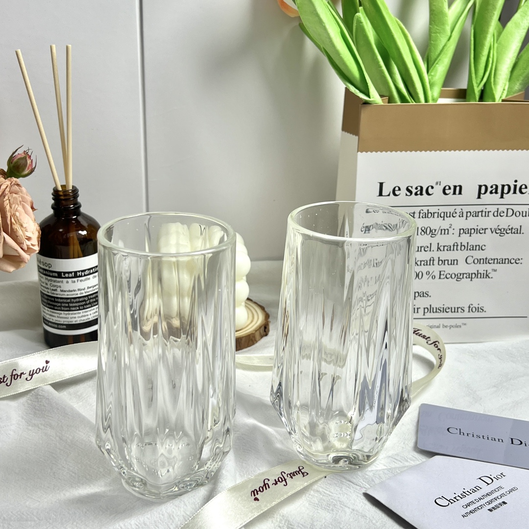 Crafted from fine glass, this set of two Dior glasses is presented in an - Comprehensive