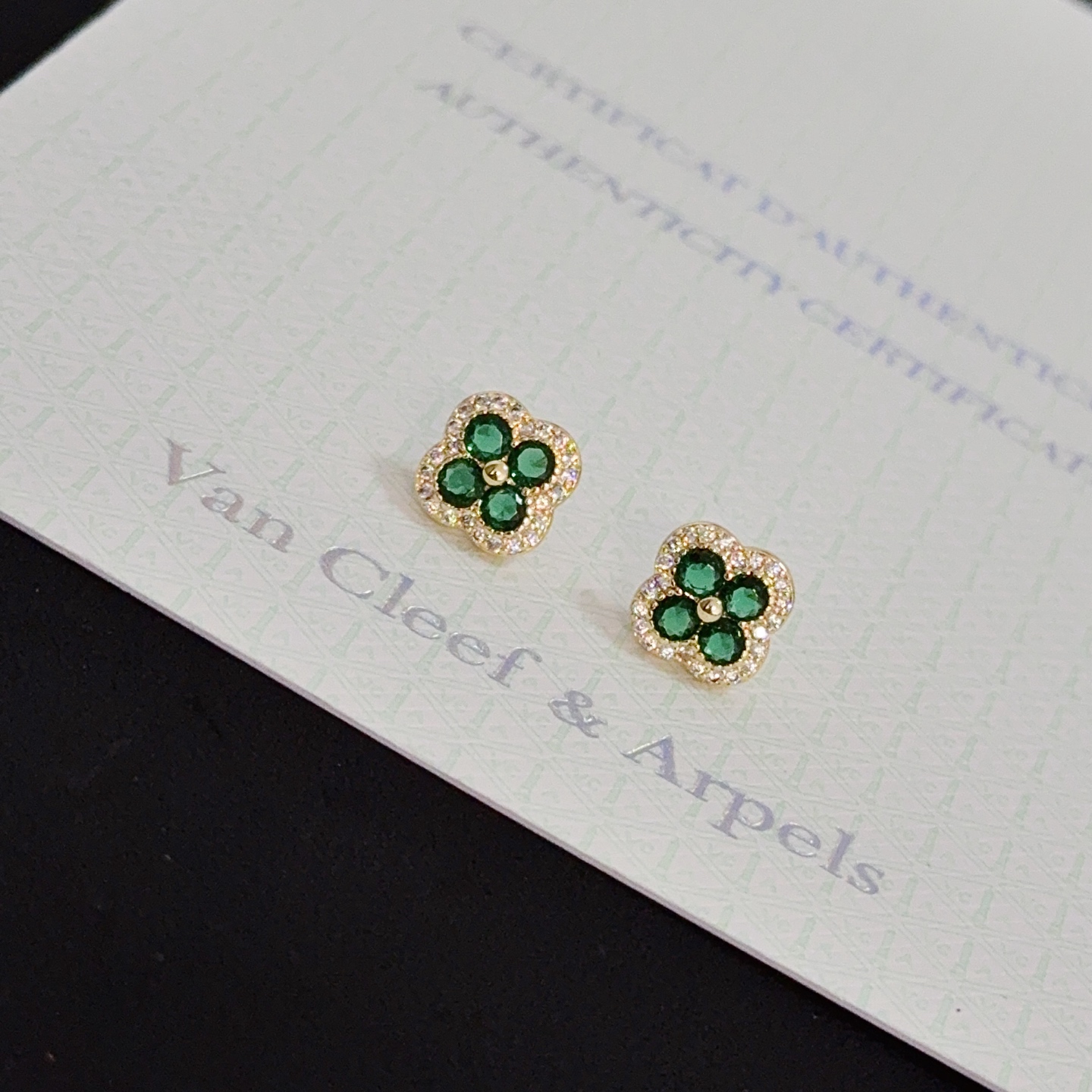 Van Cleef Arpels Alhambra earrings yellow gold metal with emerald green gemstones and white diamond accents 9mm stud diameter