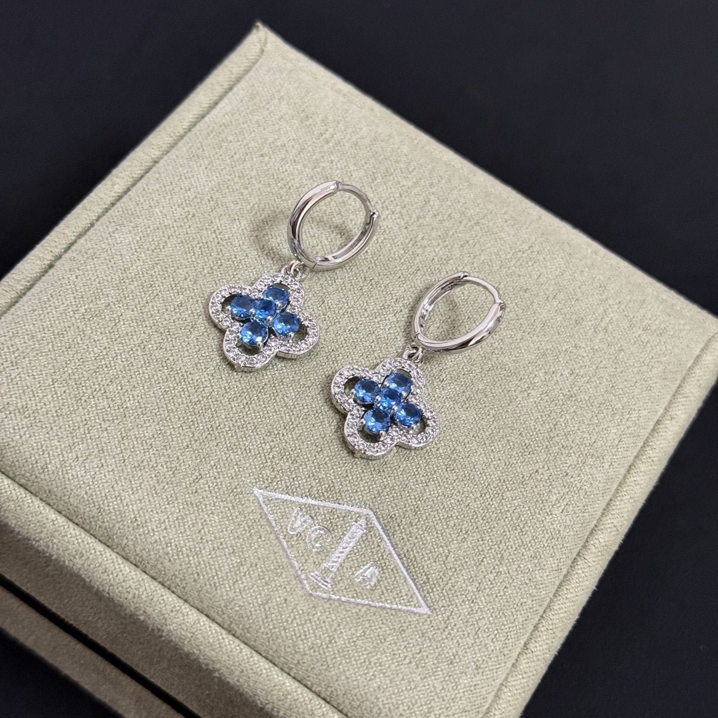 Van Cleef Arpels Alhambra earrings silver-toned white metal blue gemstones clear diamond accents 12mm hoop diameter 10mm clover charm