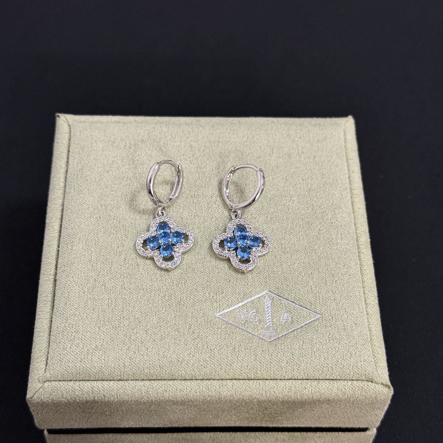 Van Cleef Arpels Alhambra earrings silver-toned white metal blue gemstones clear diamond accents 12mm hoop diameter 10mm clover charm