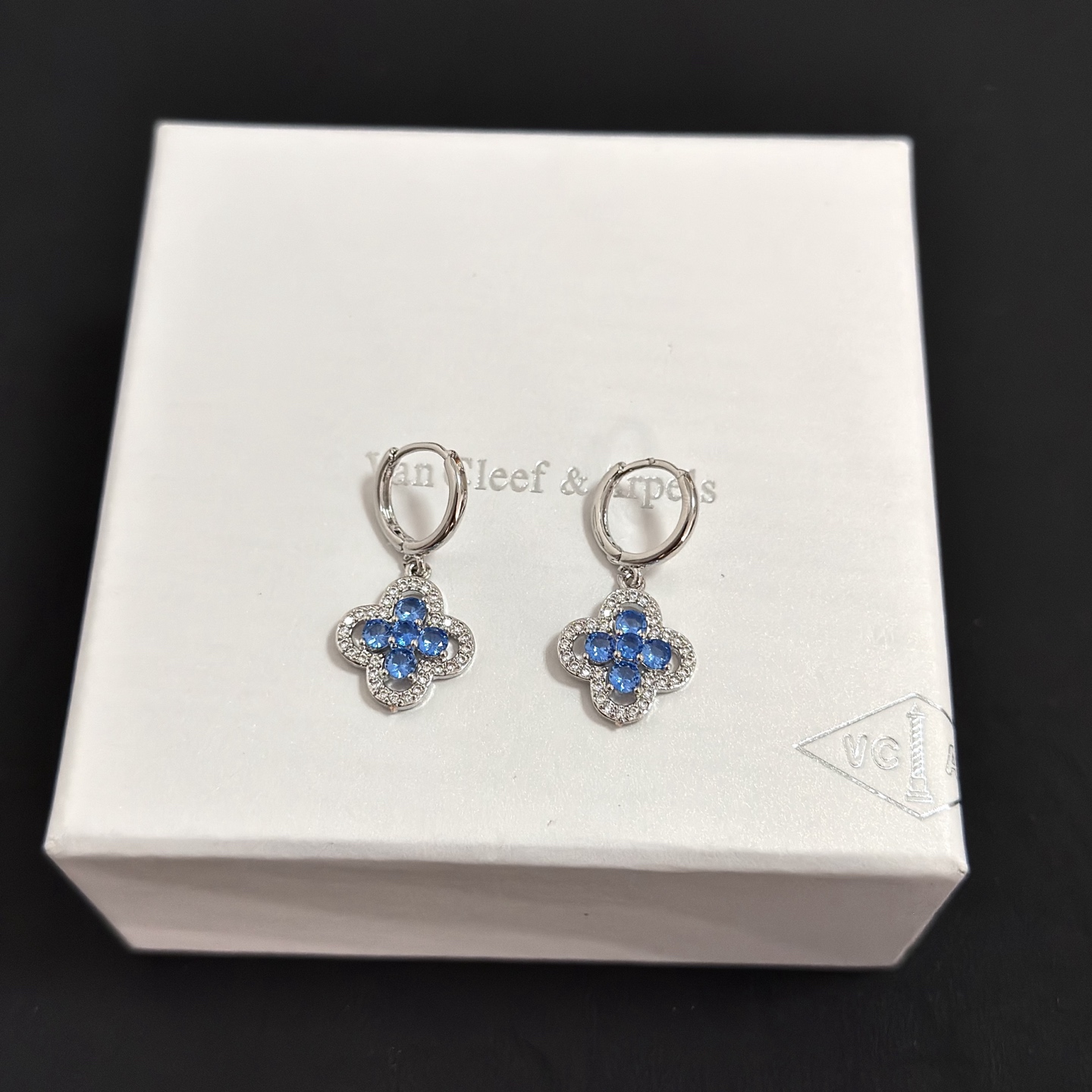 Van Cleef Arpels Alhambra earrings silver-toned white metal blue gemstones clear diamond accents 12mm hoop diameter 10mm clover charm