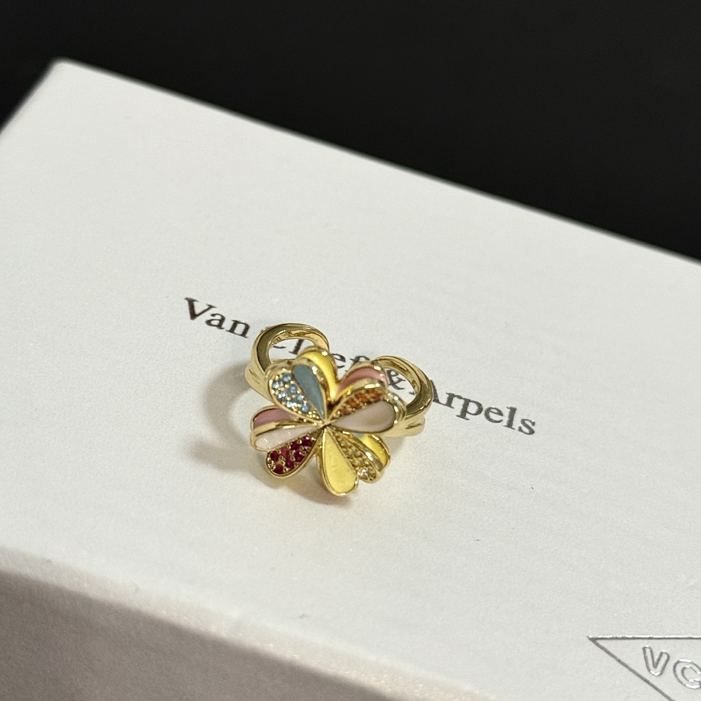 Van Cleef Arpels Alhambra Four Leaf Clover ring yellow gold metal with multicolor enamel and pave set clear red orange yellow gemstones adjustable open band