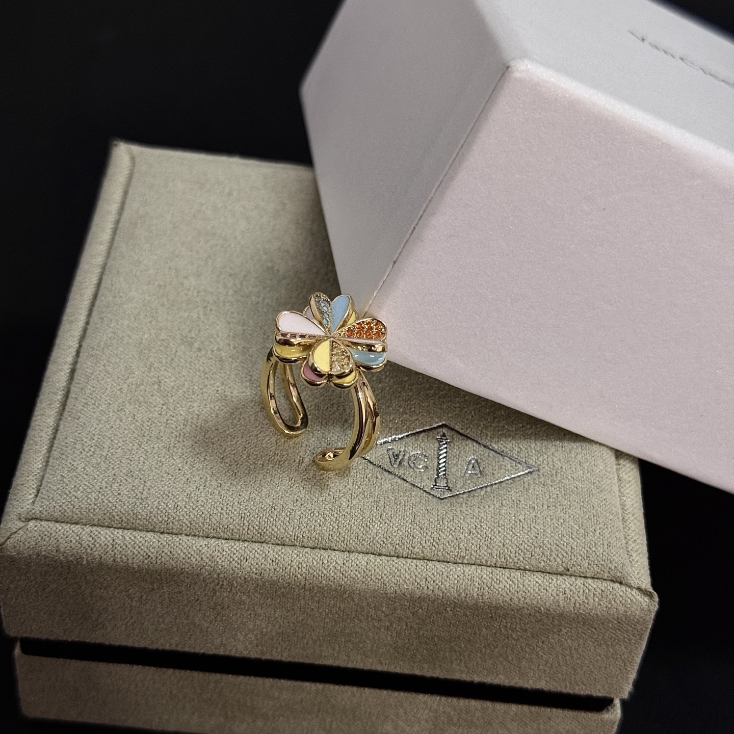 Van Cleef Arpels Alhambra Four Leaf Clover ring yellow gold metal with multicolor enamel and pave set clear red orange yellow gemstones adjustable open band