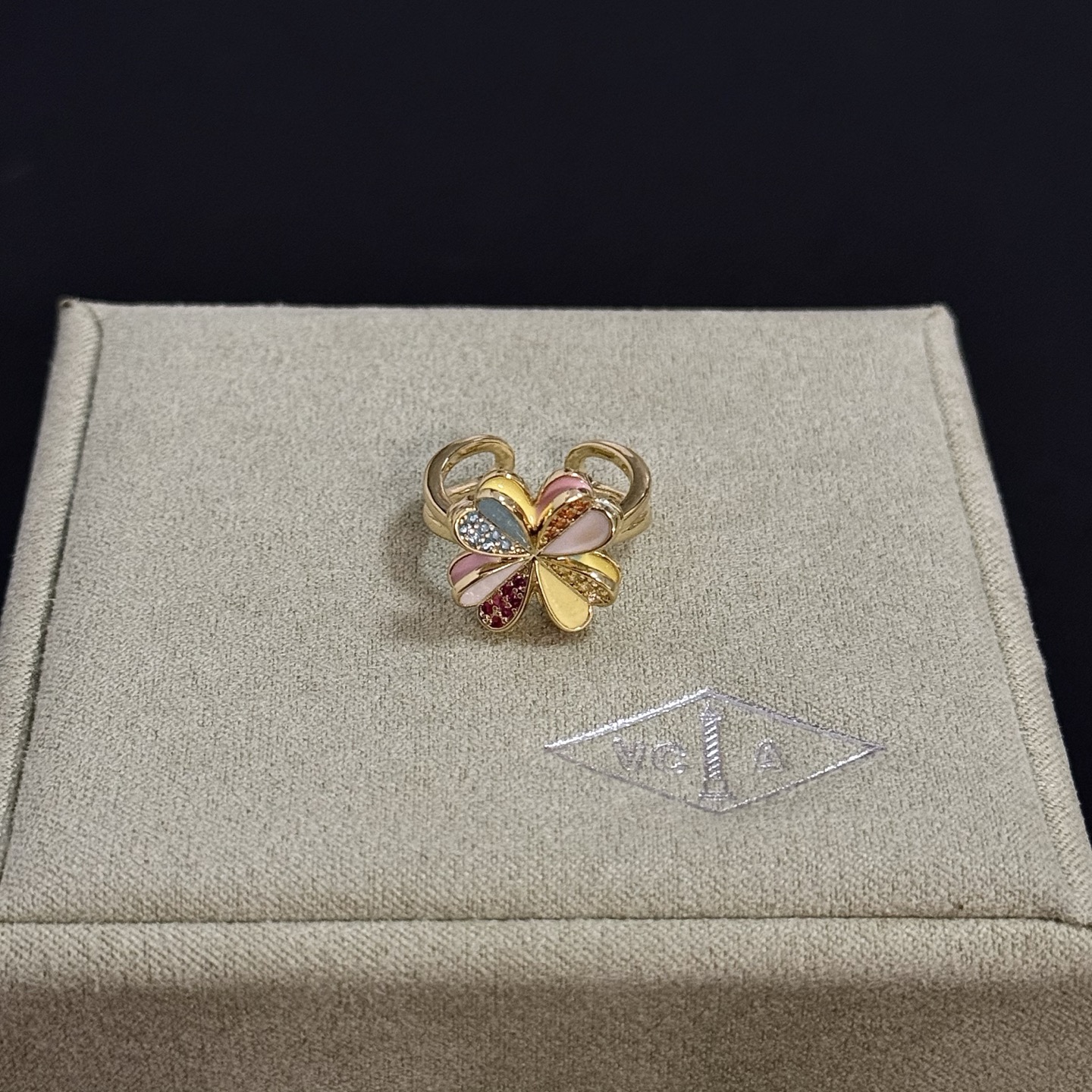 Van Cleef Arpels Alhambra Four Leaf Clover ring yellow gold metal with multicolor enamel and pave set clear red orange yellow gemstones adjustable open band