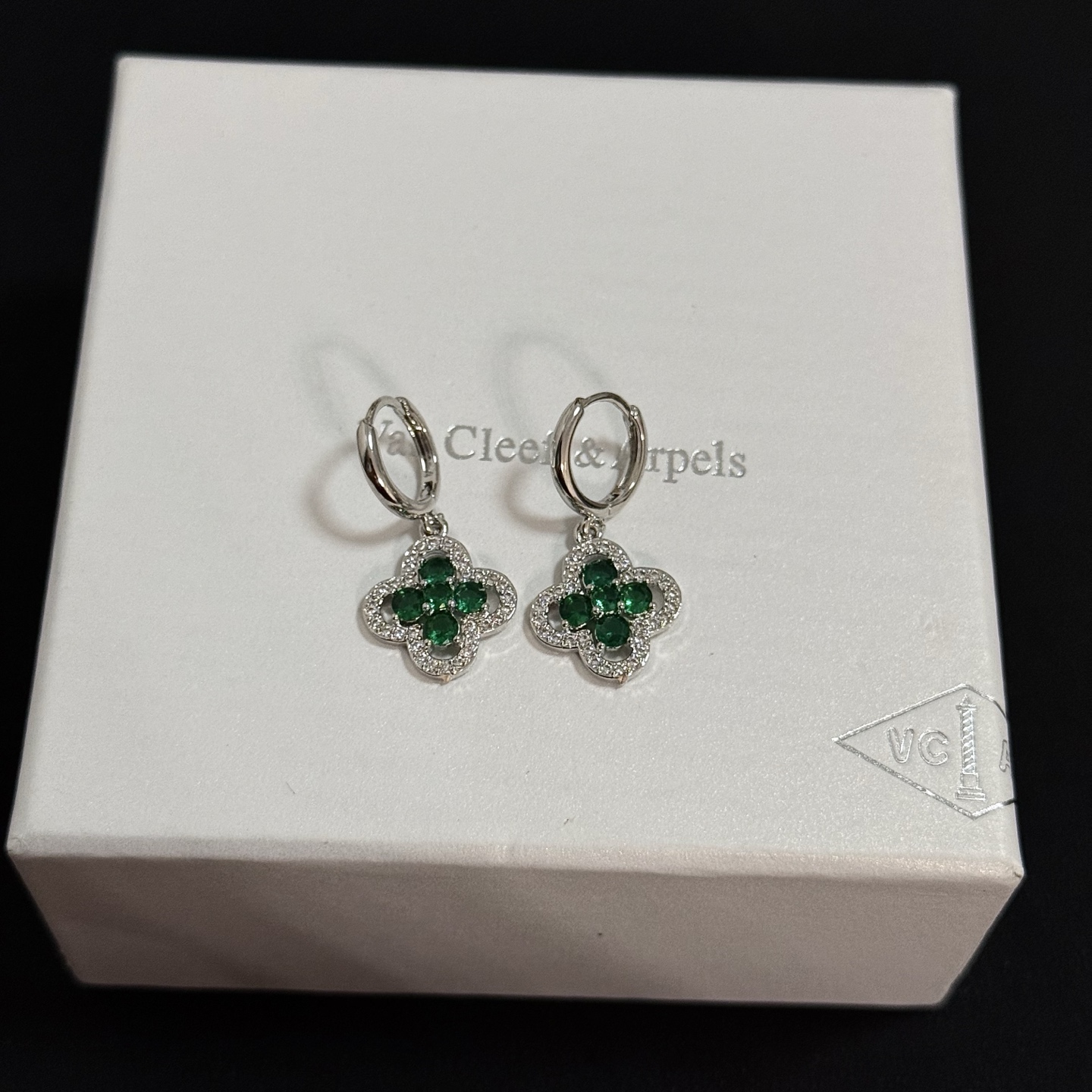 Van Cleef Arpels Alhambra earrings white gold with emerald green gemstones and clear diamond accents 12mm hoop diameter 10mm charm