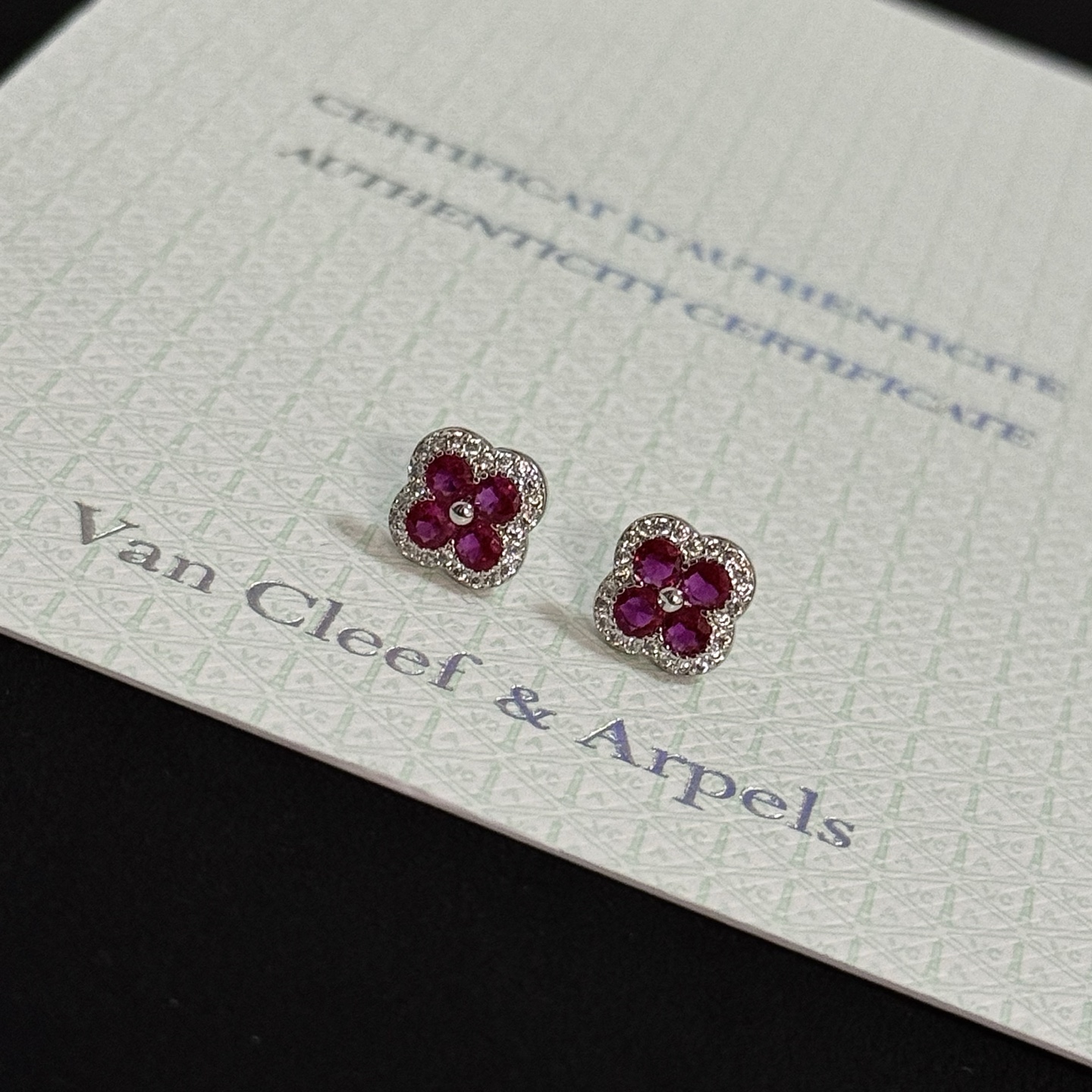 Van Cleef Arpels Alhambra earrings white gold metal ruby red gemstones white diamond accents 8mm stud diameter