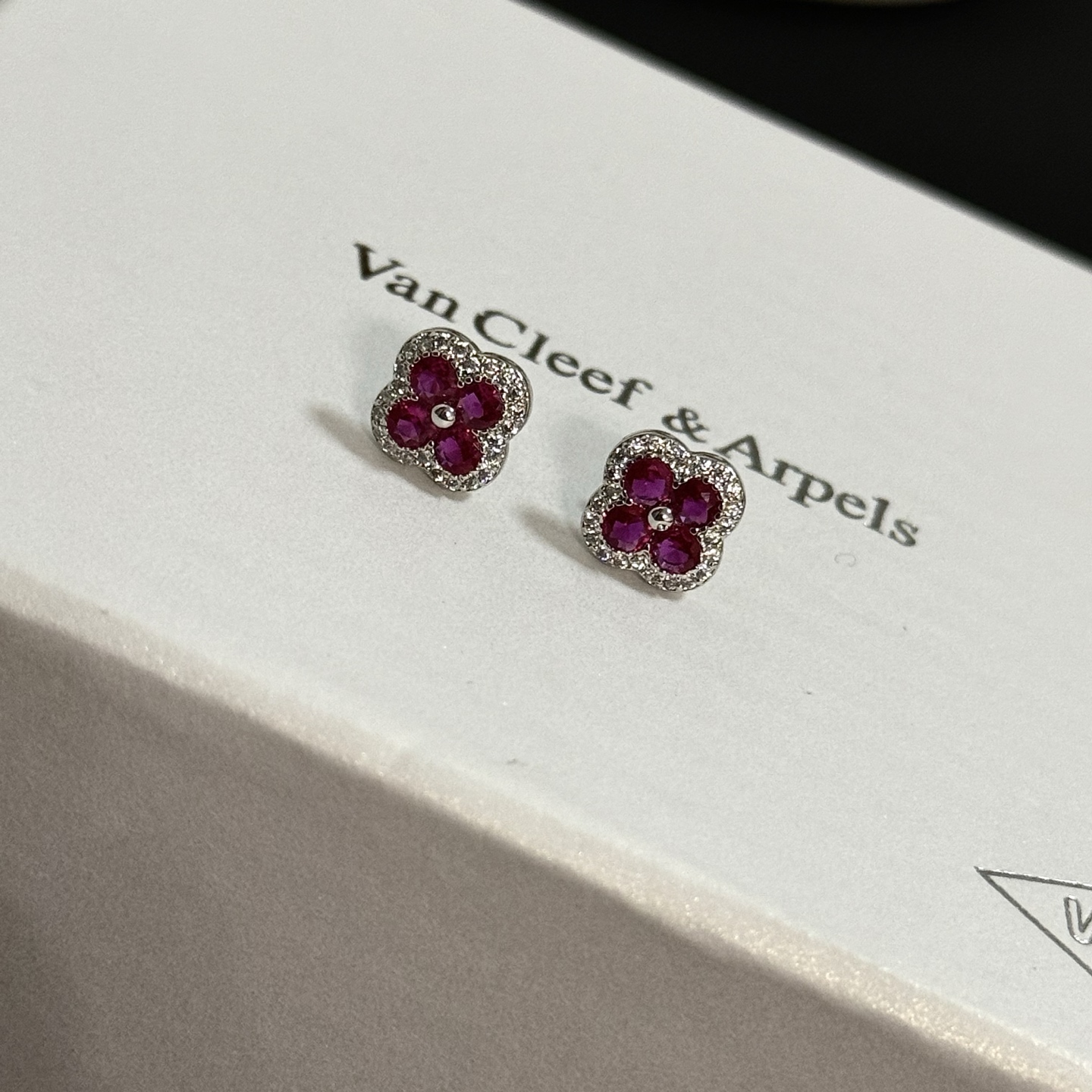 Van Cleef Arpels Alhambra earrings white gold metal ruby red gemstones white diamond accents 8mm stud diameter