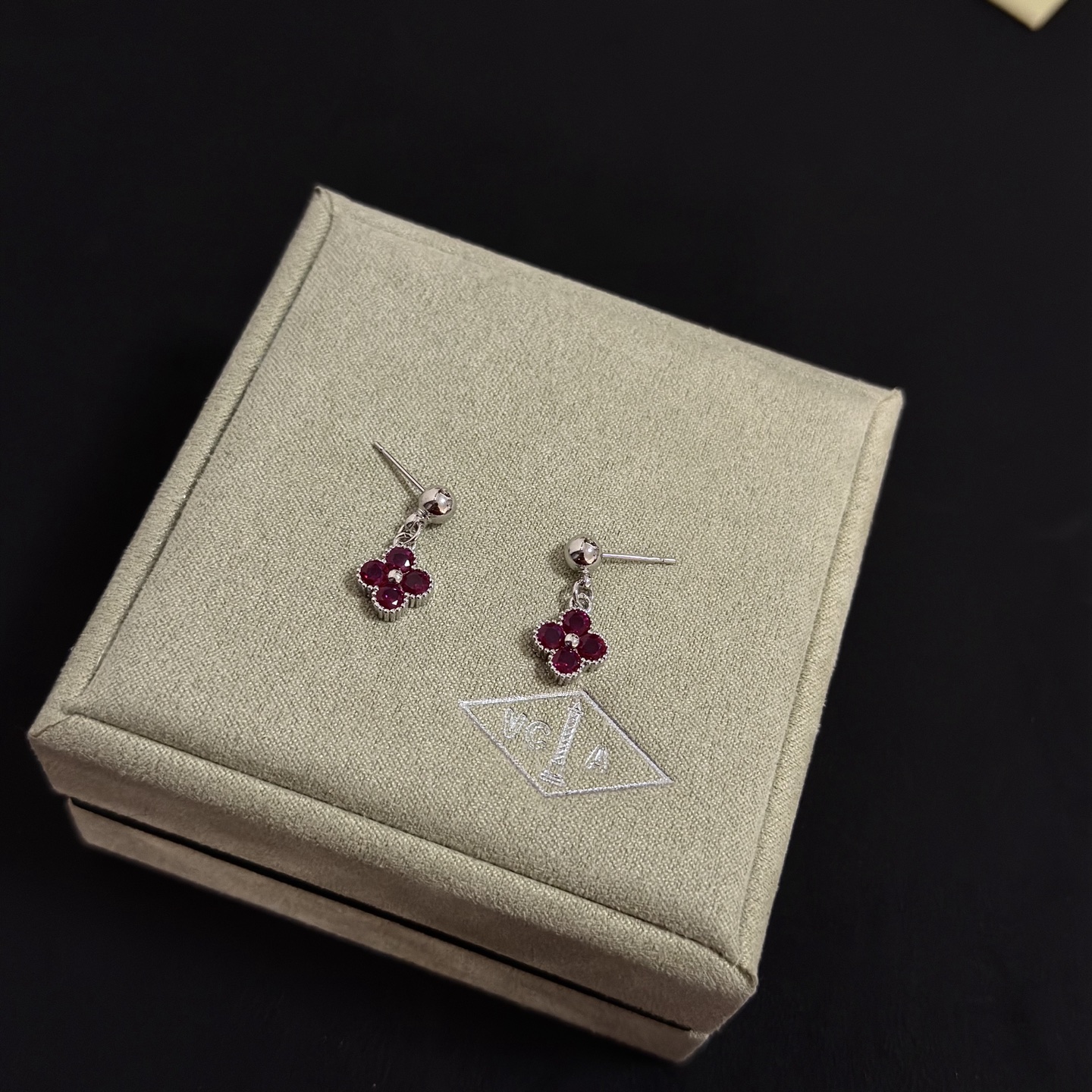 Van Cleef Arpels Alhambra earrings silver-toned white gold metal with deep ruby red gemstones and small white diamond accent 1 5cm drop length