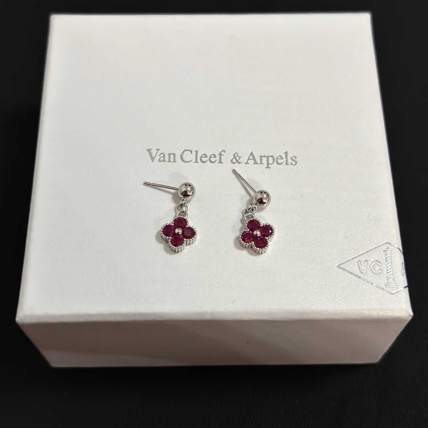 Van Cleef Arpels Alhambra earrings silver-toned white gold metal with deep ruby red gemstones and small white diamond accent 1 5cm drop length