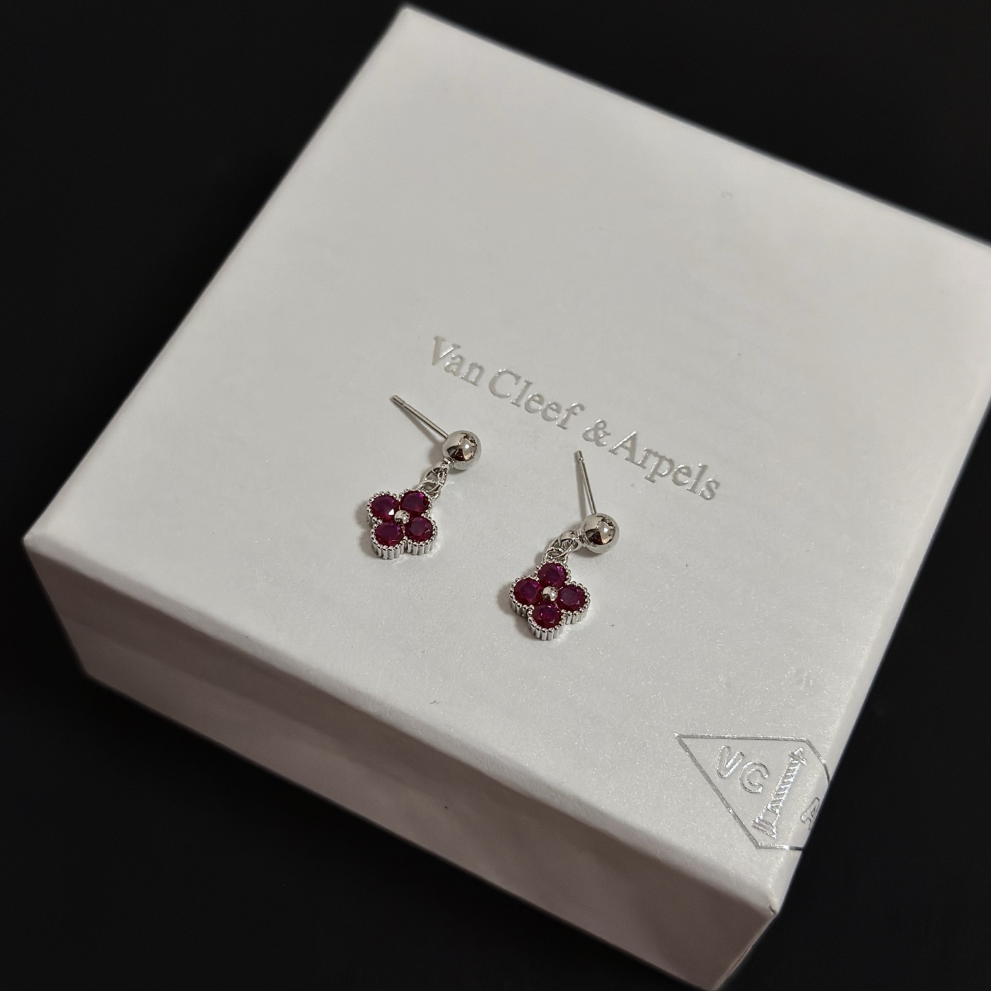 Van Cleef Arpels Alhambra earrings silver-toned white gold metal with deep ruby red gemstones and small white diamond accent 1 5cm drop length