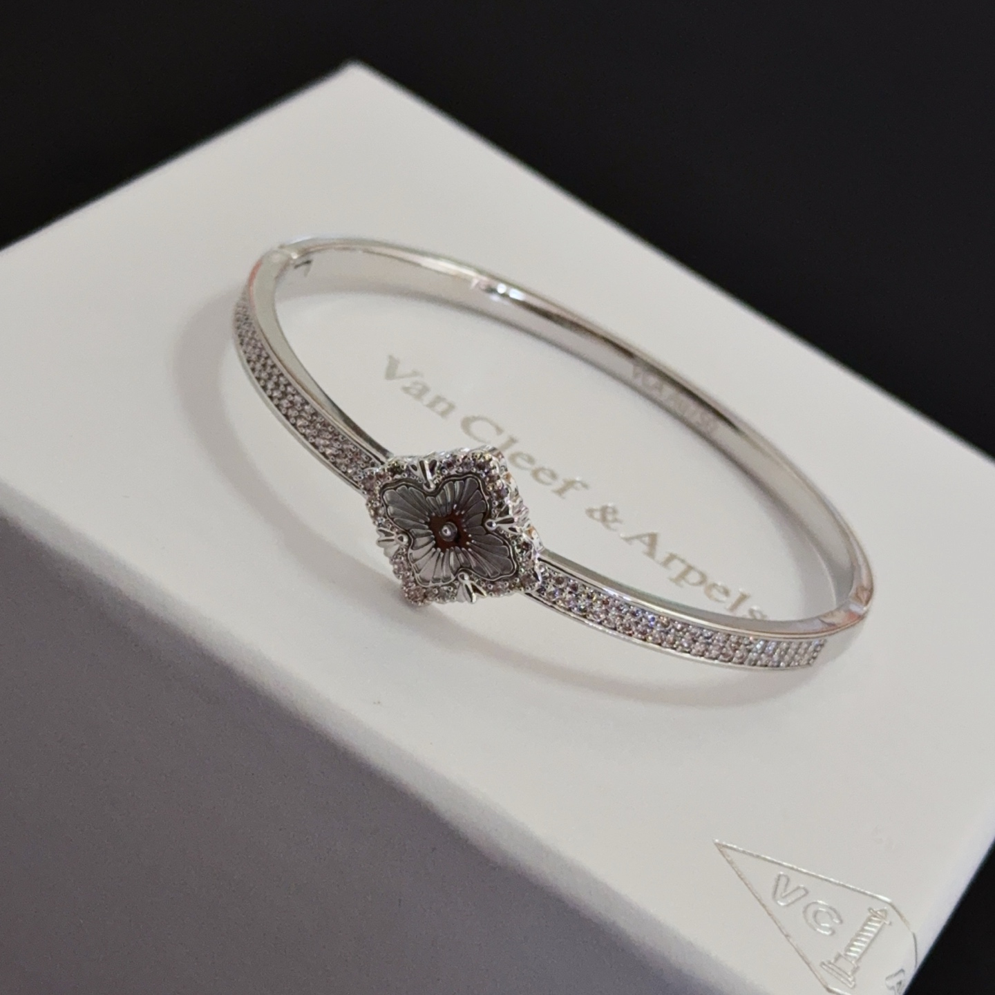 Van Cleef Arpels Alhambra bracelet silver-toned metal with clear diamond accents and grey engraved clover motif 17cm