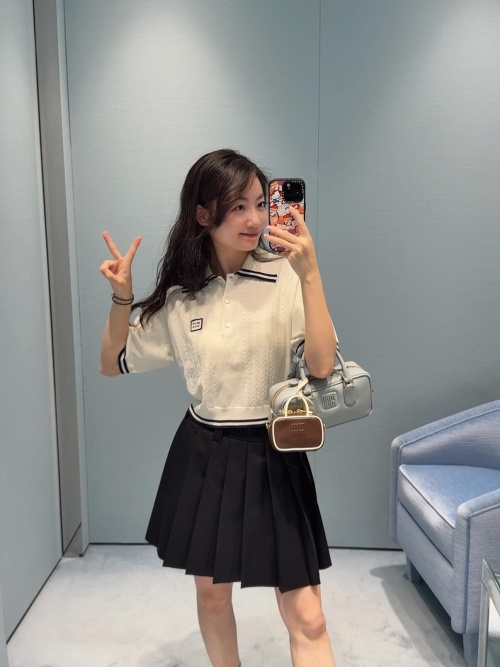 Miu Miu Pleated Mini Skirt with Appliqué Logo - Versatile & Chic 1 Miu Miu Pleated Mini Skirt with Appliqué Logo - Versatile & Chic
