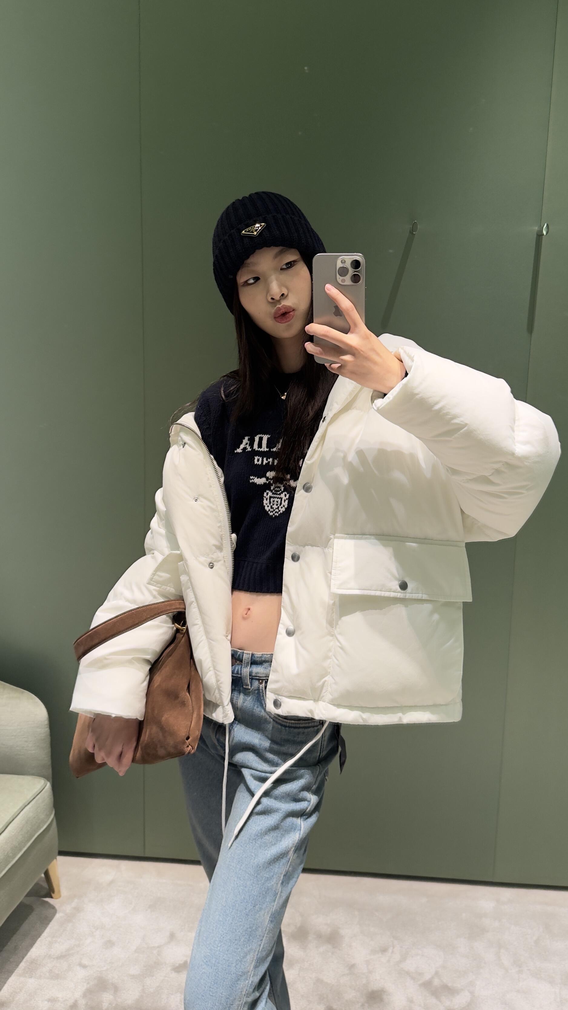 💰批690 🆕Prad* 25Fw秋冬新款 三角徽标白色连帽夹克羽绒服丨⚠独家yb开发！高版出品！采用品牌标志性的 Re-Nylon 再生尼龙面料（由海洋回收塑料净化再生而成），兼具防水功能性与柔和哑光质感，米白色调在秋冬衣橱中更显干净高级；70%鹅绒填充饱满蓬松，连帽带抽绳可调节松紧，下摆抽绳自由控制廓形；双侧大贴袋兼具工装实用性与视觉层次感，日常出行随手置物便利又时髦。现货发售S/M/L