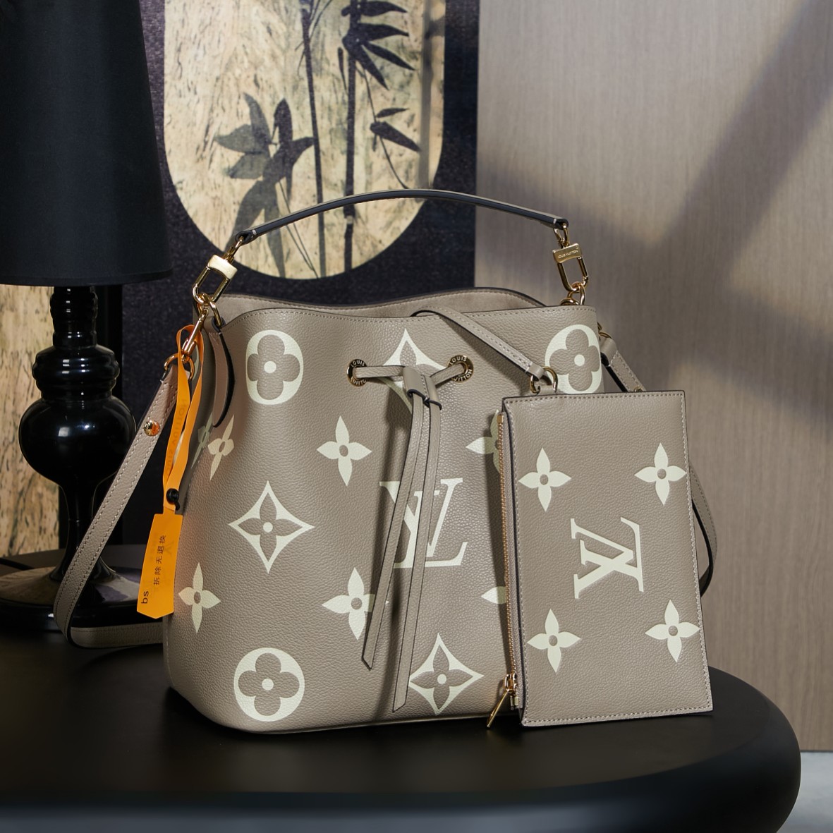 M45555 Dynamic Code: The NéoNoé medium bucket bag features LV initials and Monogram flowers printed and embossed on leather for a striking visual effect. The interior pocket can securely hold valuable items, and the shoulder strap is adjustable for shoulder or crossbody wear. Made of embossed grained cowhide leather with microfiber lining, metal hardware, central zip compartment, and adjustable and detachable shoulder strap. Dimensions: 26.0 x 26.0 x 17.5 cm (length x height x width). image 1