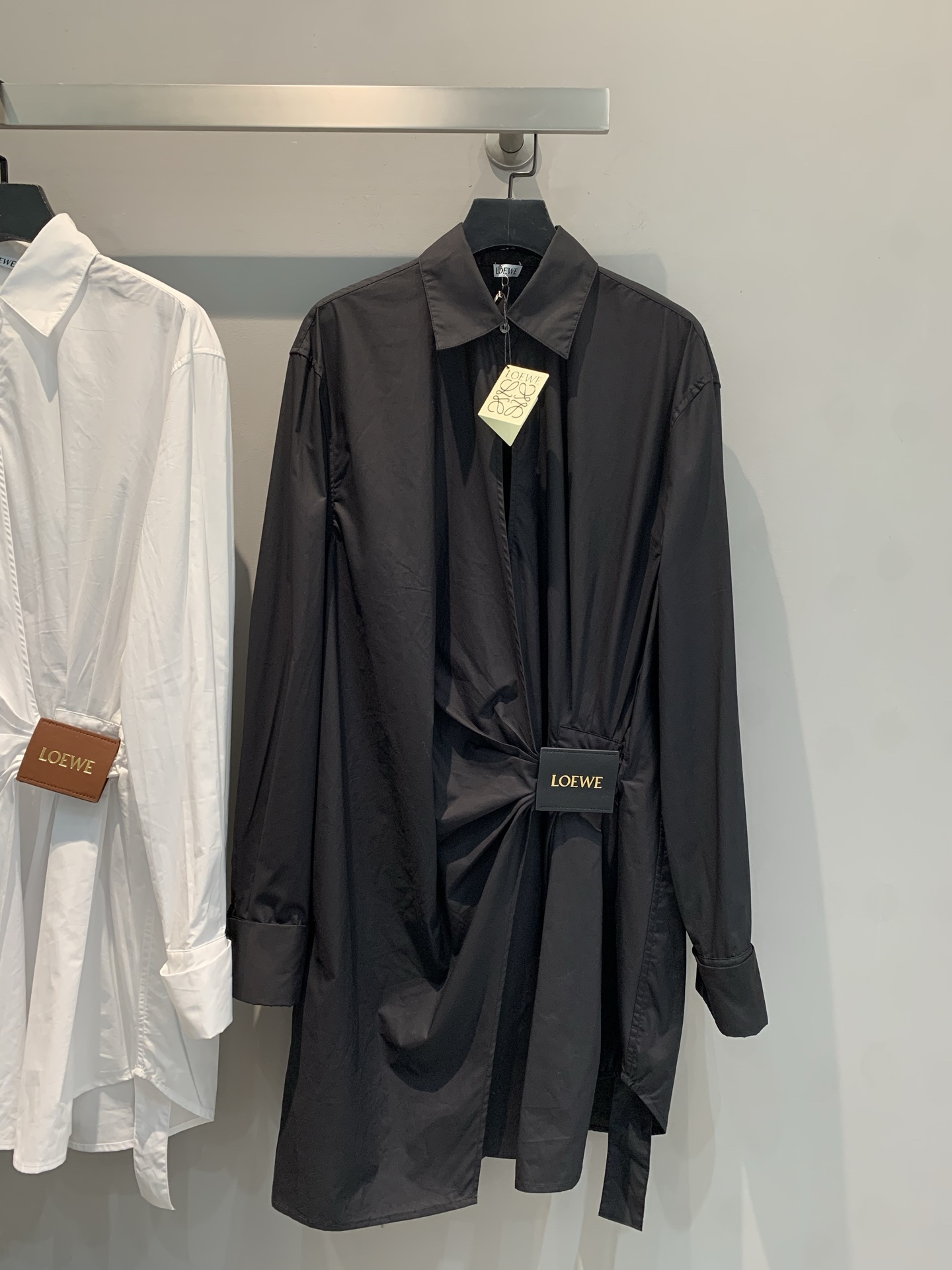 NO:327107,New models are shipped. Original development. Loew*2025 early spring new irregular leather tag button shirt dress. It uses 100% imported pure cotton fabric. The texture is comfortable and delicate. The unique leather tag knot design breaks the routine and shows elegant style in a casual manner. The iconic logo leather tag embellishment is low-key and luxurious. The loose style is to accommodate all body shapes. Whether it is single or layered, it can easily create a high-end outfit, helping you to show your unique charm on urban streets or in exquisite occasions~ SML, loewe, skirts, alexander wang19860909新款出货啦 原版开发 Loew*2025早春新款不规则皮牌扣衬衣式连衣裙.采用进口百分百纯棉面料.质感舒适细腻.独特的皮扣打结设计,打破常规,随性中尽显优雅格调.标志性logo皮牌点缀,低调奢华.宽松版型,包容各种身形,无论是单穿还是叠搭,都能轻松打造高级感穿搭,助你在都市街头或是精致场合,皆能绽放独特魅力~码数SML,,loewe,skirts,alexander wang,Women's clothing