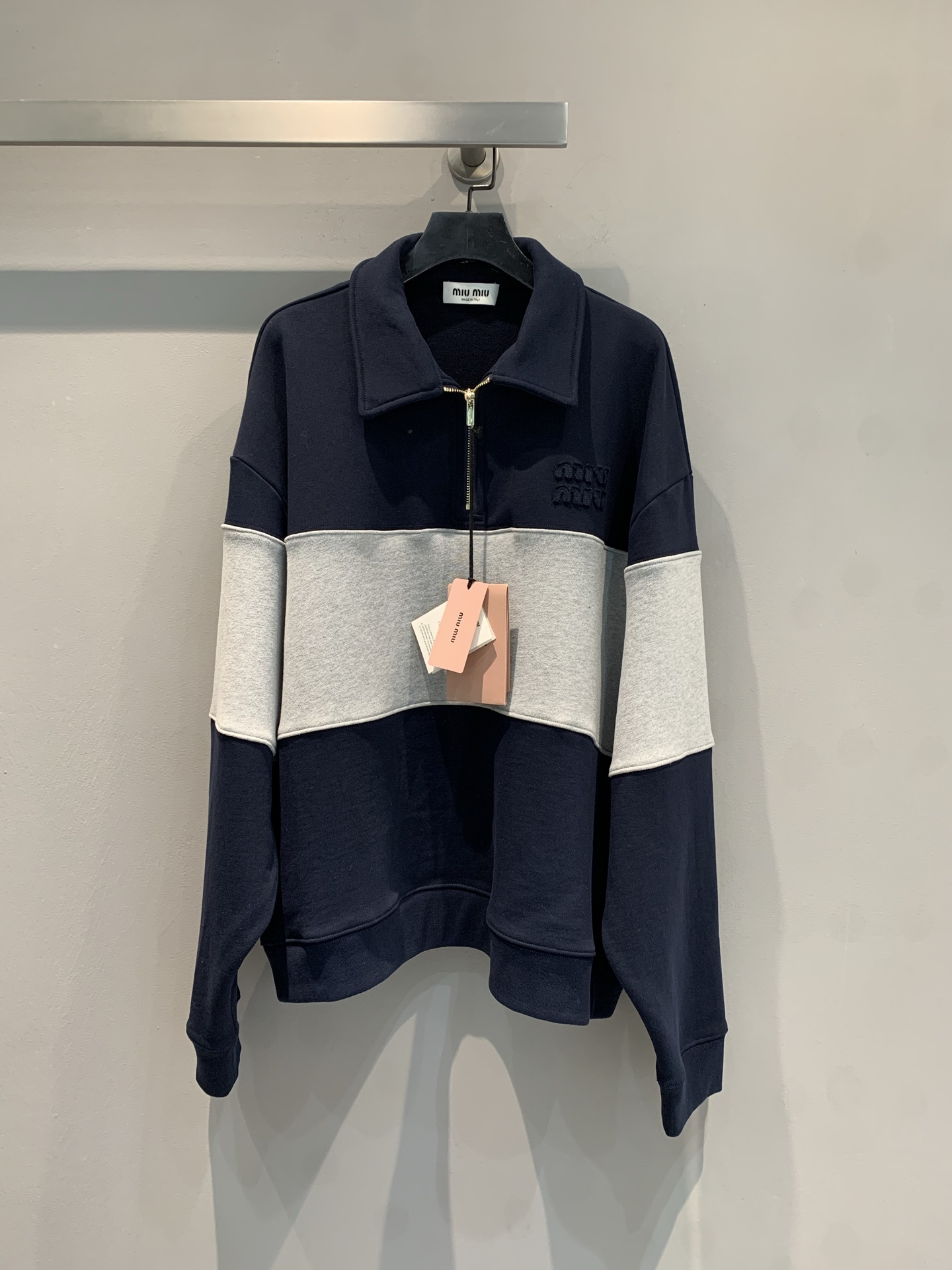 NO:326993,The new model is shipped. Original development. Miumi*2025 early spring new letter embroidered contrasting half-open collar top. This top adopts contrasting color splicing design. The combination of hidden blue and light gray is simple and unique. The semi-zippered Polo collar style combines casual and fashionable feeling. The details of the brand logo embroidery on the chest add recognition and exquisiteness, which is suitable for creating a casual and fashionable daily style. SML, miumiu, alexander wang19860909新款出货啦 原版开发 Miumi*2025早春新款字母刺绣撞色半开领上衣.这件上衣采用撞色拼接设计,藏蓝与浅灰搭配简约又不失个性,半拉链Polo领款式兼具休闲感与时尚感,胸前品牌标识刺绣细节增添辨识度与精致度,适合打造休闲又时髦的日常造型.码数SML,,miumiu,alexander wang,Women's clothing