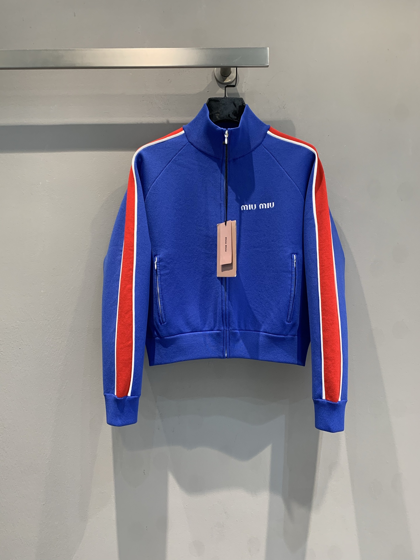 NO:686197,New shipment: Original developed MiuMi* 2026 spring series webbing zipper sports jacket, blue main color + red stripe contrasting design, full of vitality! High-quality polar fleece material, soft and warm, super comfortable for daily wear. Stand-up collar zipper + chest brand embroidery, exquisite details and high recognition. Zipper pockets on both sides, practical and fashionable, retro college style combined with modern sporty sense, paired with short skirts or casual pants of the same color, you can easily get a youthful and energetic look!  Size SML,,miumiu,skirts,jackets & coats,19860909新款出货 原版开发MiuMi*2026春季系列织带拉链运动外套,蓝色主色+红色条纹撞色设计,活力满满!高品质摇粒绒材质,柔软又保暖,日常穿搭超舒适.立领拉链+胸前品牌刺绣,细节精致,辨识度高.两侧拉链口袋,实用又时髦,复古学院风融合现代运动感,搭配同色系短裙或休闲裤,轻松get青春活力造型! 码数SML,,miumiu,skirts,jackets & coats,,Women's clothing