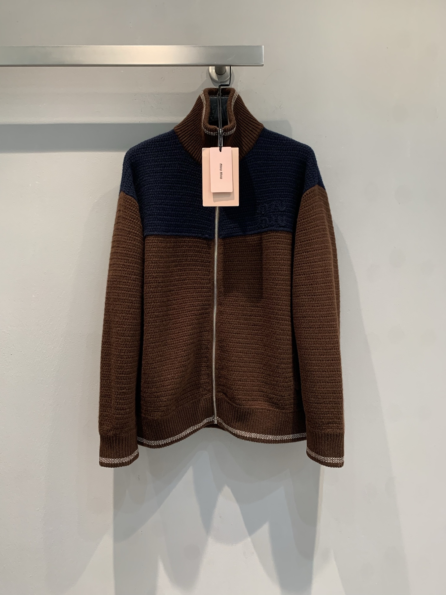 NO:730030,New model shipped, original development  Miumi*2026 new early spring college style contrast cashmere knitted cardigan. It adopts a classic contrast design. The splicing of dark blue and caramel brown is both retro and fashionable. The ribbed cuffs and hem details enhance the texture. It is paired with a metal zipper and lapel design. The overall style is more academic.  A fusion of style and retro casual. Wear a white shirt + black Polo shirt underneath, a high-waisted skirt and a brown belt on the lower body. The overall look is rich in layers and can be worn for daily commuting or dating. Size SML, miumiu, skirts, shirts,19860909新款出货啦原版开发 Miumi*2026早春新款学院风撞色羊绒针织开衫.采用经典撞色设计,深蓝与焦糖棕的拼接既复古又时髦,罗纹袖口和下摆细节提升质感,搭配金属拉链和翻领设计,整体风格偏向学院风与复古休闲的融合.内搭白色衬衫+黑色Polo衫,下身搭配高腰短裙和棕色皮带,整体造型层次丰富,日常通勤或约会穿搭.码数SML,,miumiu,skirts,shirts,,Women's clothing