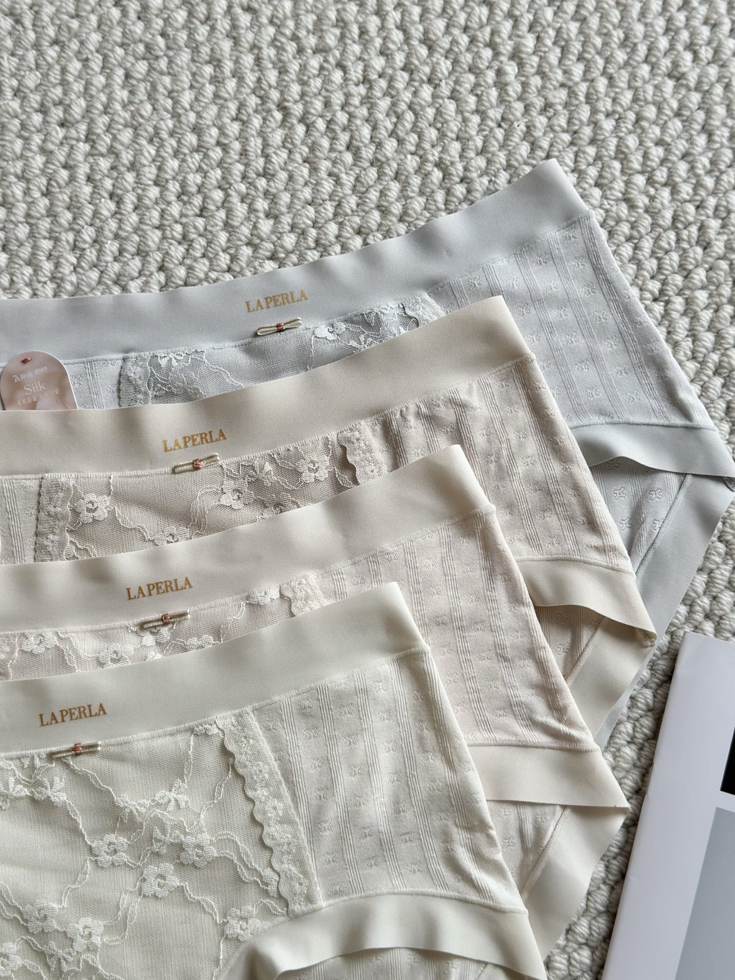 LaPerla莫代乐蕾丝拼接内裤，女性专属呵护材质: 这是一张衣物洗唛的图片，展示了以下信息：货号: •