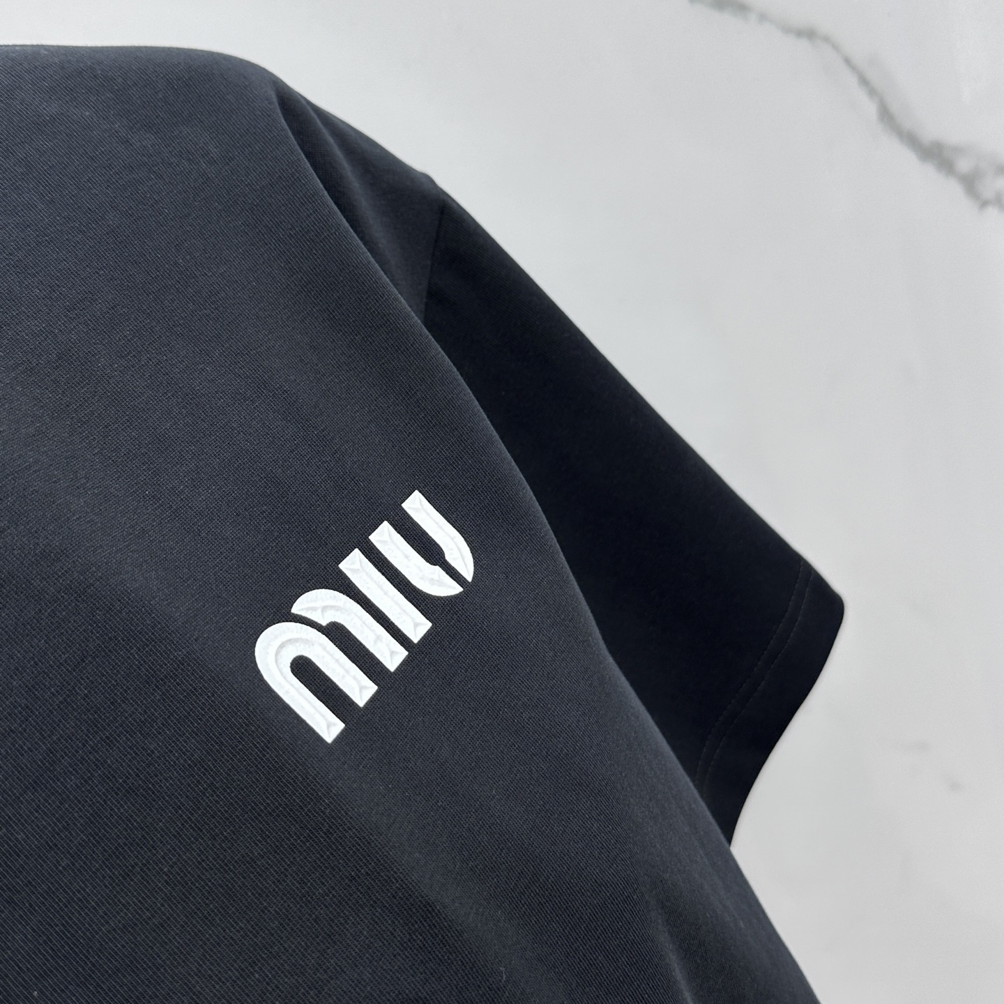 Miu Miu T-Shirt: Spring/Summer Crewneck Tee with Embossed Logo 7 i1744221191527 985 0 5