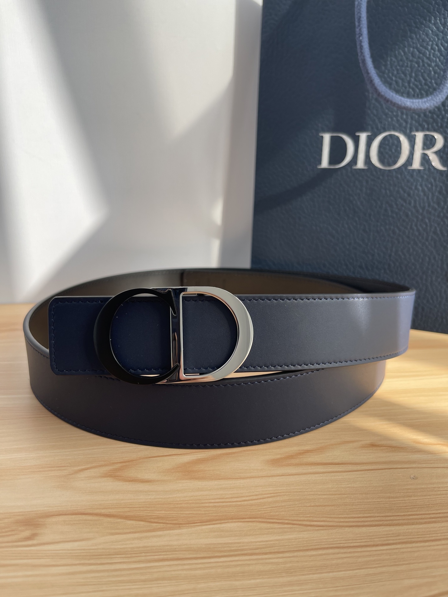 P 这款 35 毫米双面腰带结合典雅气质与摩登风范。 配一面采用黑色 Dior Gravity 印花效果