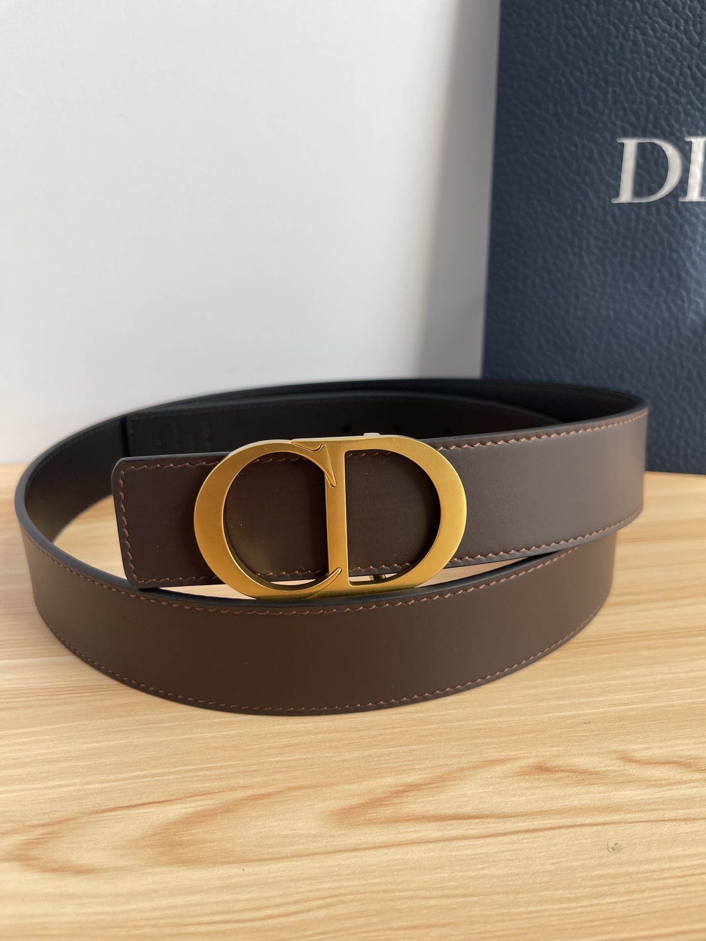 P 这款 35 毫米双面腰带结合典雅气质与摩登风范。 配一面采用黑色 Dior Gravity 印花效果