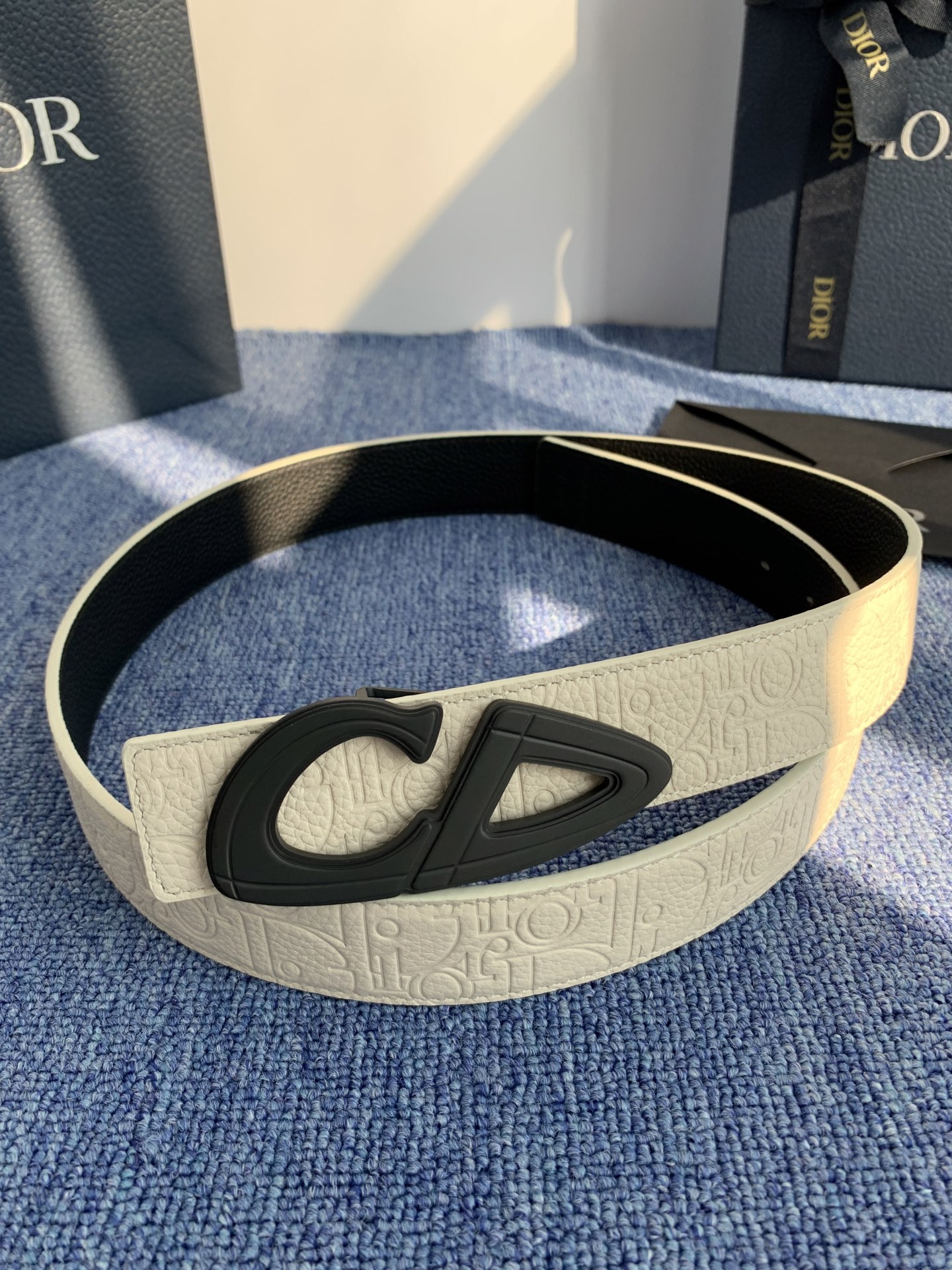 采用黑色粒面牛皮革精心制作，饰以镌刻有 Dior 的针扣和黑色金属覆层铜合金 CD Icon 标志腰带环