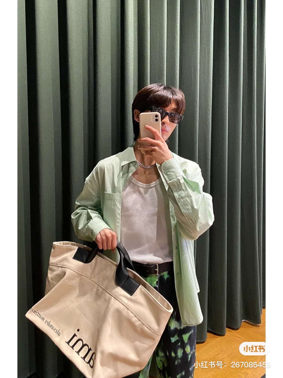 A versatile, minimalist AMI handbag presented in soft off-white - Comprehensive