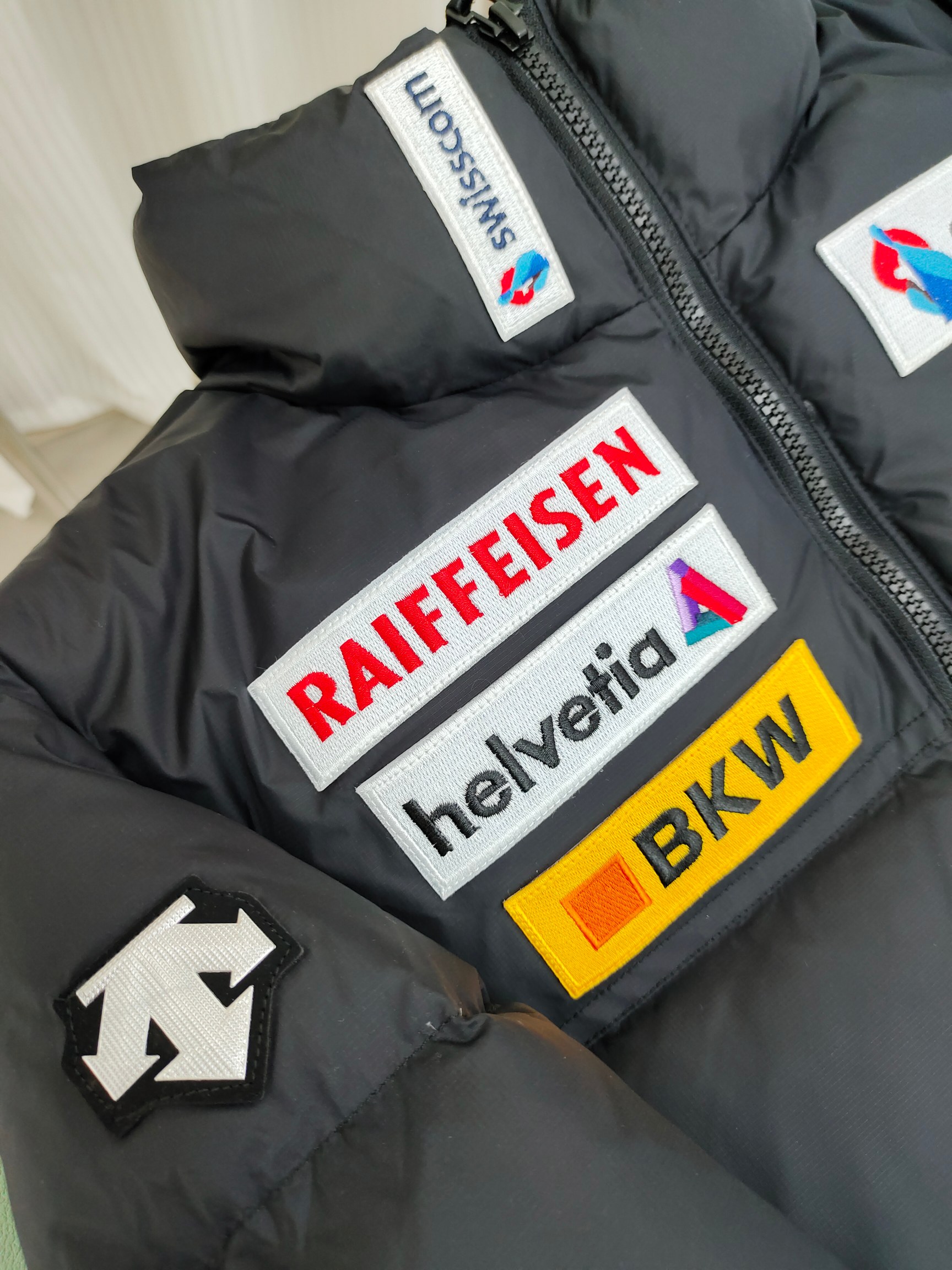 正p级💰315 迪桑特奥迪多标老款羽绒滑雪服

迪桑特DESCENTE SKI STYLE系列 HEAT NAVI 科技内衬 瑞士国家队合作 运动休闲短款羽绒服 

DESCENTE迪桑特奥迪合作多标经典短款羽绒服。在胸前和手臂上的 LOGO是合作队赞助商的商标，不同配色在一起却格外和谐，同时多了一丝街头感。另外整件都采用了白鸭绒填充，保暖又轻便，短装夹克的版型也特别显比例，可以说是集合滑雪元素和街头风最好的冬季单品。经典黑白配色。
尺码：XS-2XL
颜色：黑色.白色.