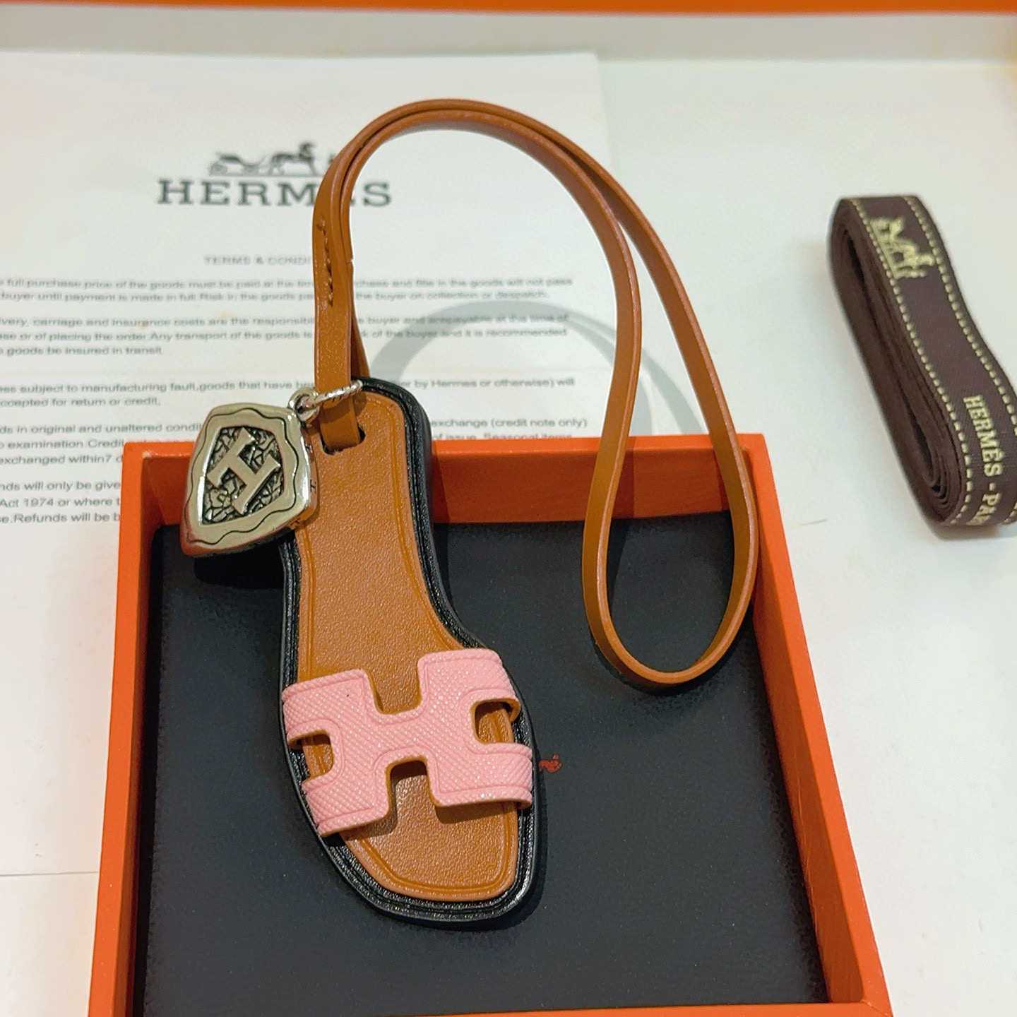 Hermes Oran Sandal Bag Charm pendant tan leather pink Epsom leather antique silver-tone metal black edge trim 17cm strap length