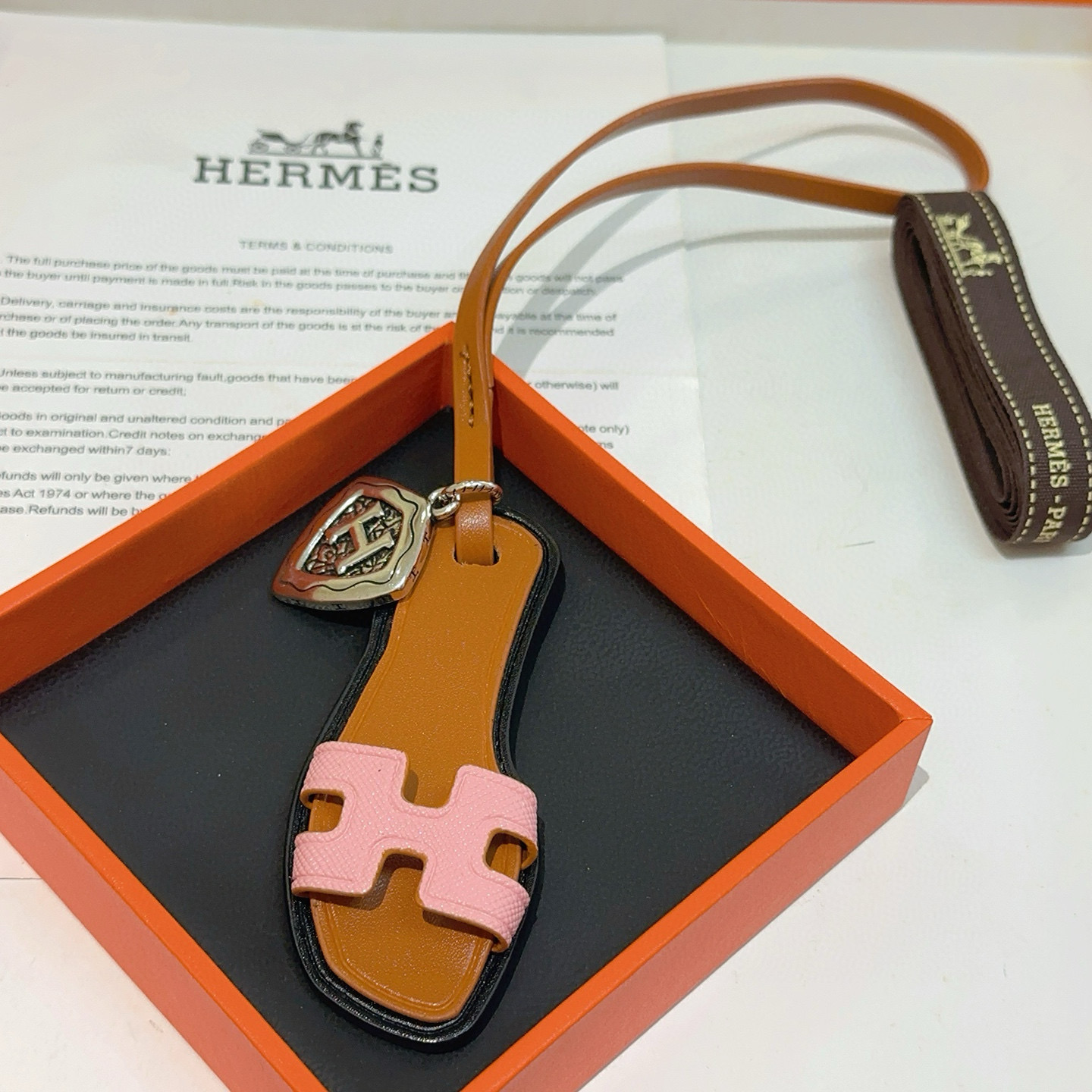 Hermes Oran Sandal Bag Charm pendant tan leather pink Epsom leather antique silver-tone metal black edge trim 17cm strap length