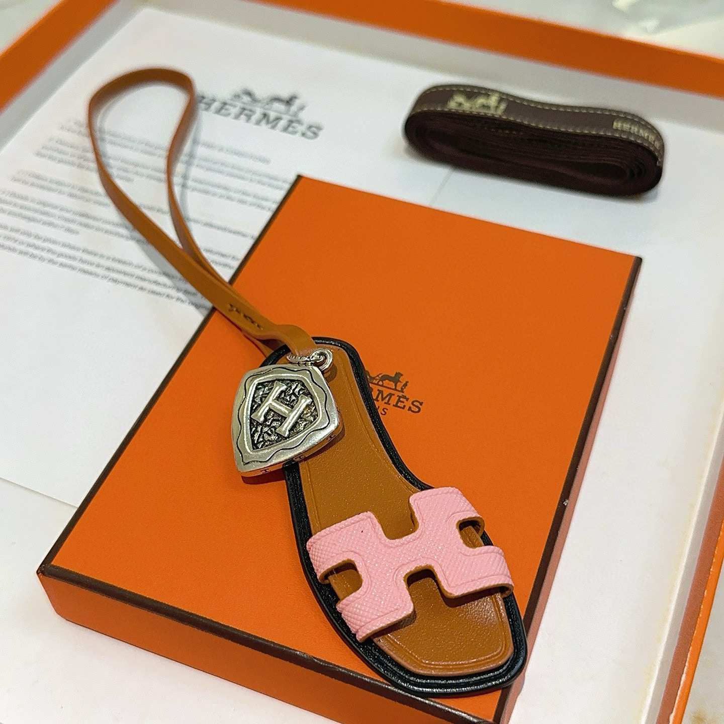 Hermes Oran Sandal Bag Charm pendant tan leather pink Epsom leather antique silver-tone metal black edge trim 17cm strap length