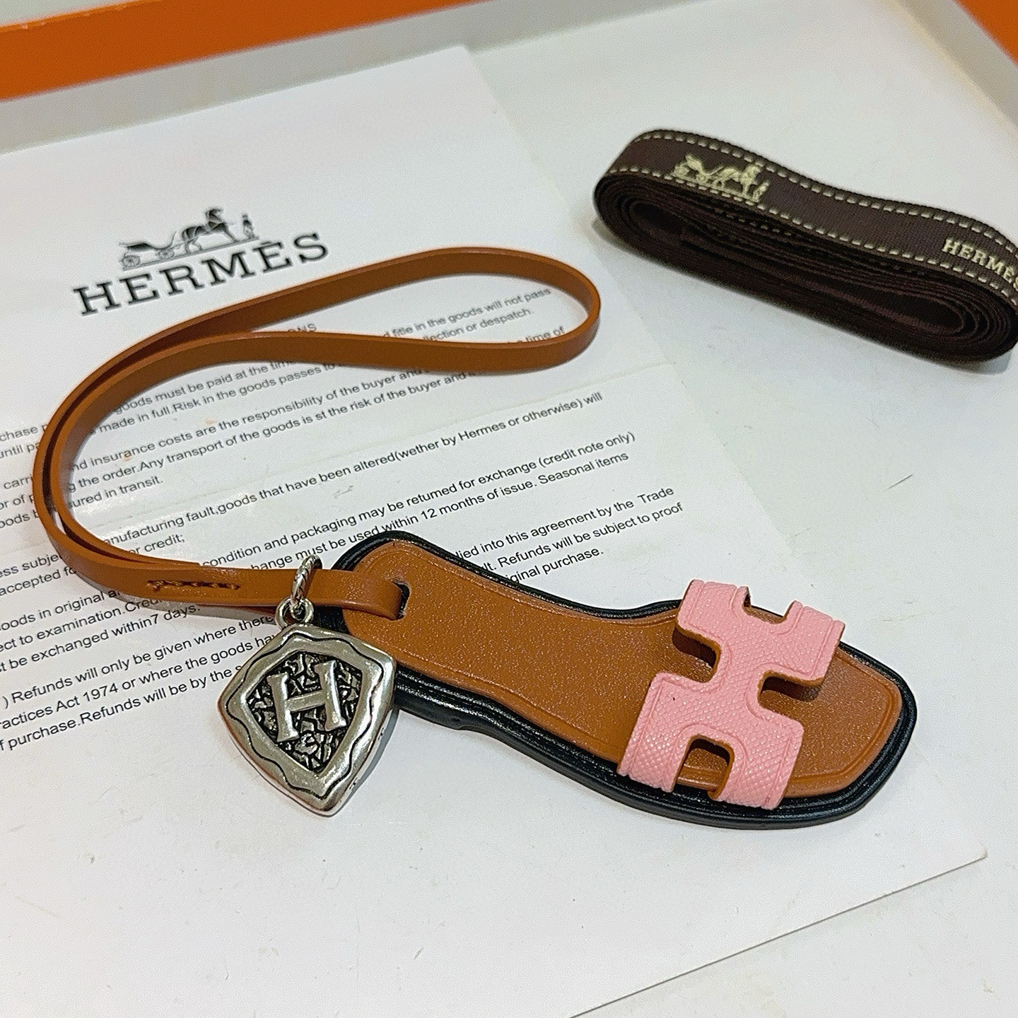 Hermes Oran Sandal Bag Charm pendant tan leather pink Epsom leather antique silver-tone metal black edge trim 17cm strap length