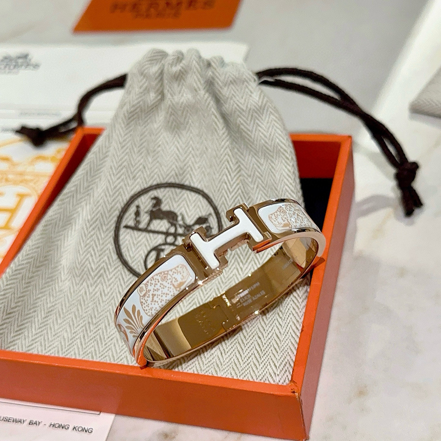 Hermes Clic H Leopard Print Bangle bracelet Rose gold metal with white enamel and light gold leopard pattern PM