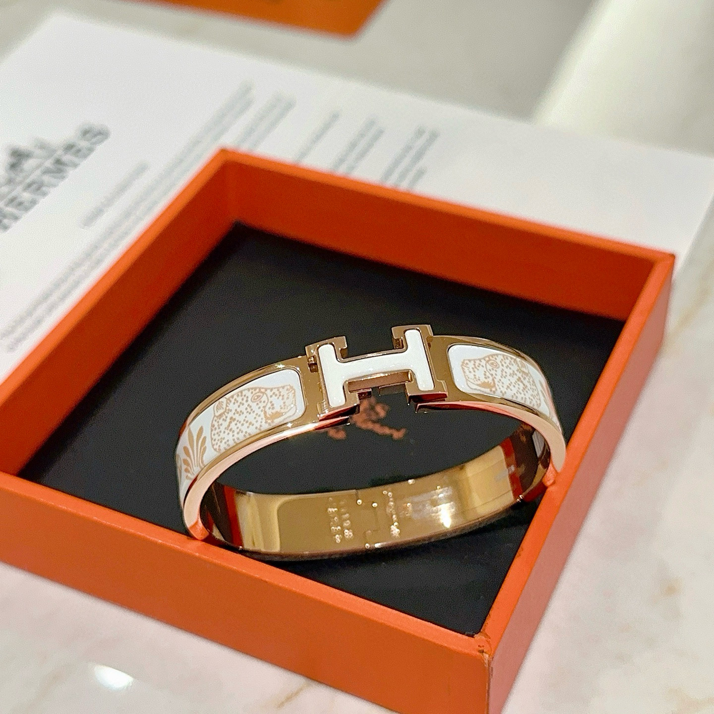 Hermes Clic H Leopard Print Bangle bracelet Rose gold metal with white enamel and light gold leopard pattern PM