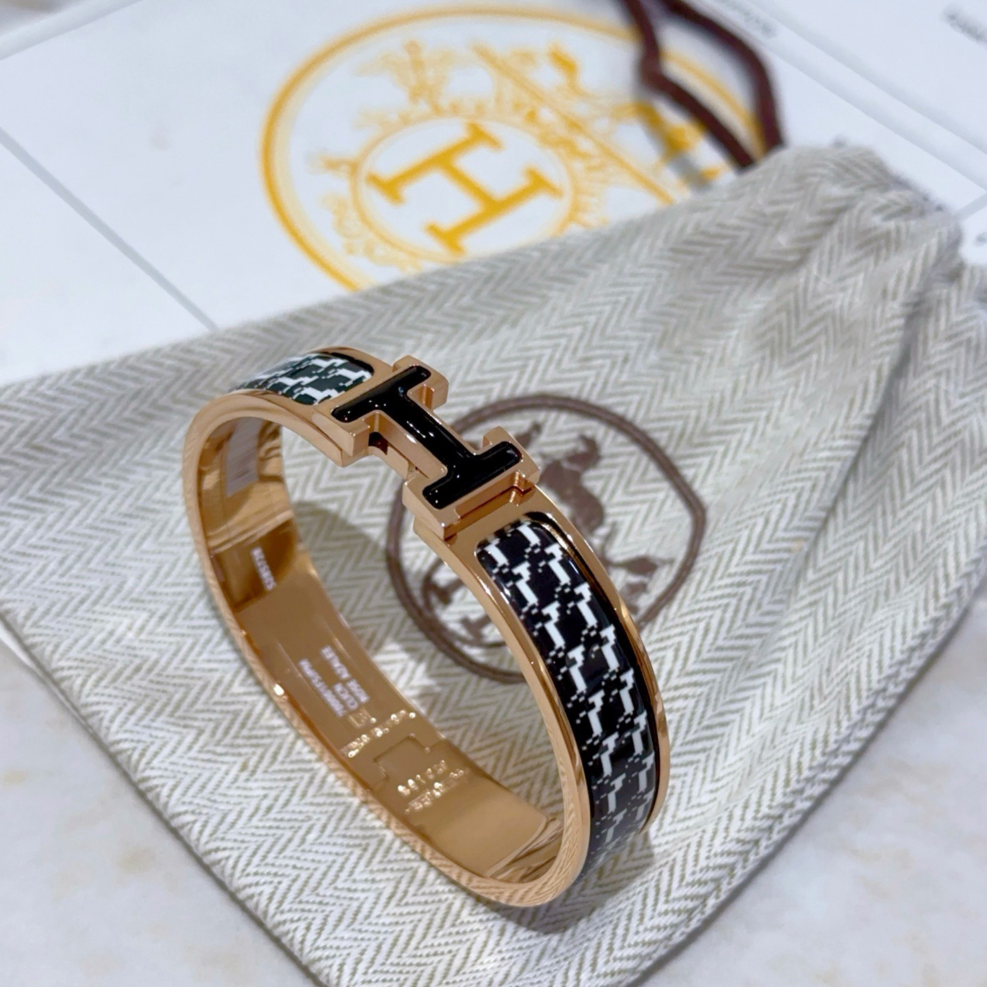 Bracelet Hermes Clic H métal plaqué or rose émail pied-de-poule noir et blanc fermoir H émail noir PM