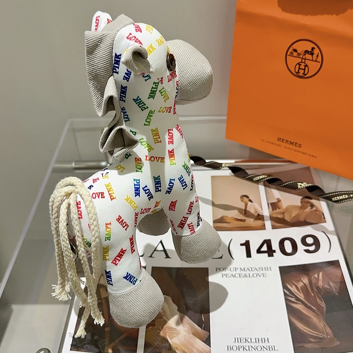 Hermes Rodeo Pegase Horse Charm pendant White fabric with multicolor LOVE and PINK text print light gray corduroy accents cream rope tail brass-toned metal eye detail 25cm